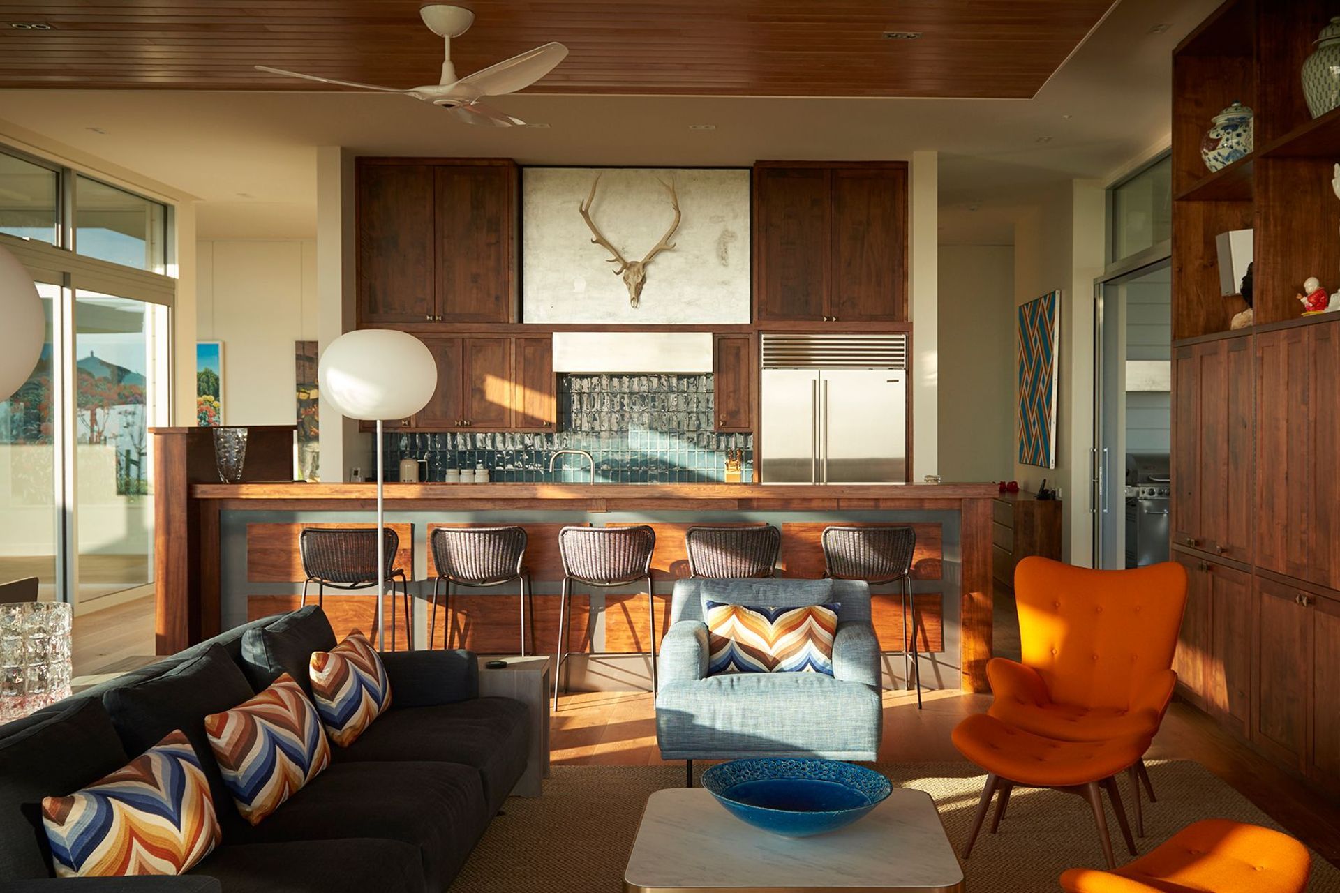 The interior design by Brigit Christie features a natural base palette of colours and materials, with accents of colour and texture, and bold mid-century modern furniture.