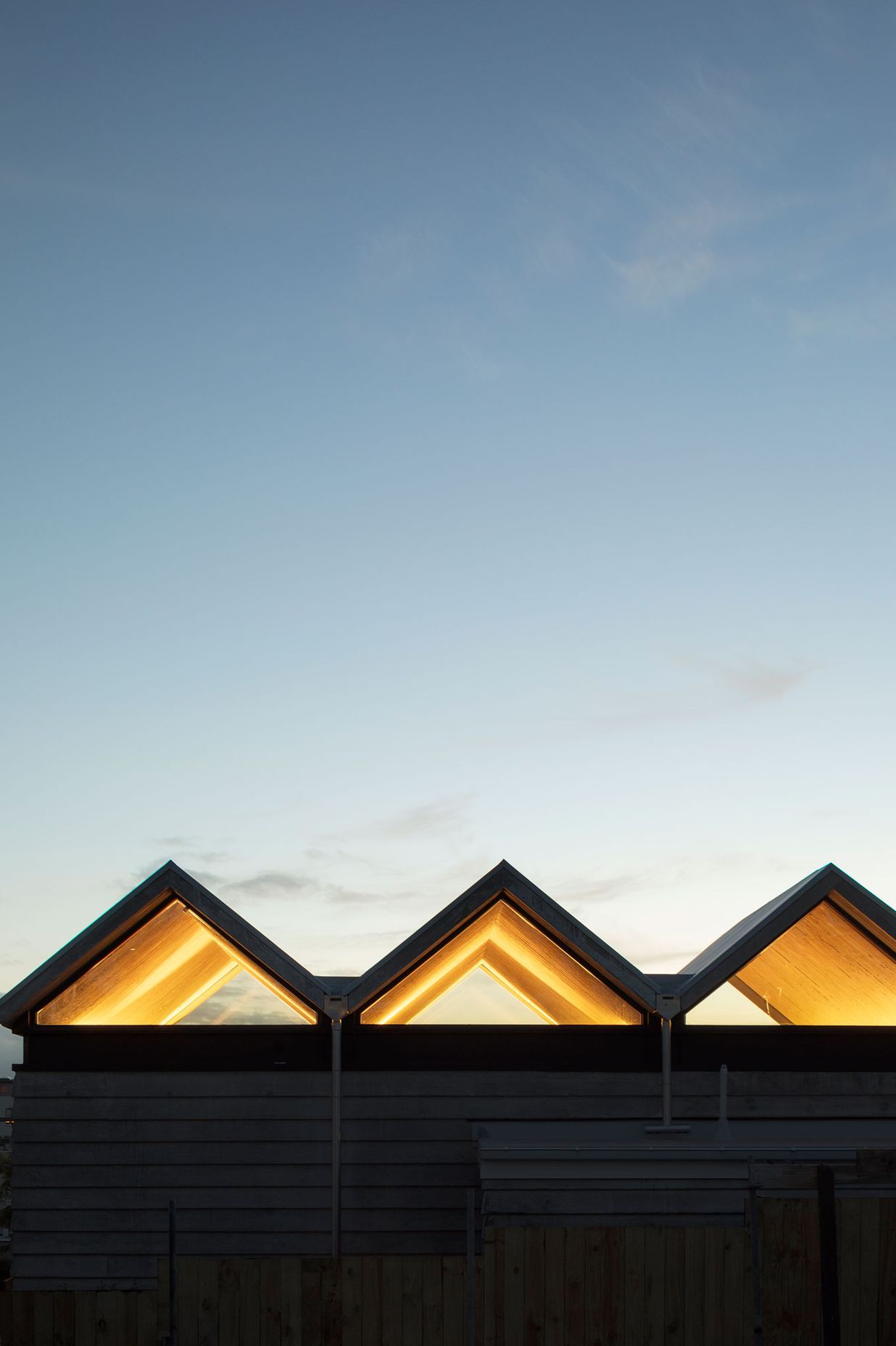 At night the pleated roof is underlit to dramatic effect and framing the setting sun .