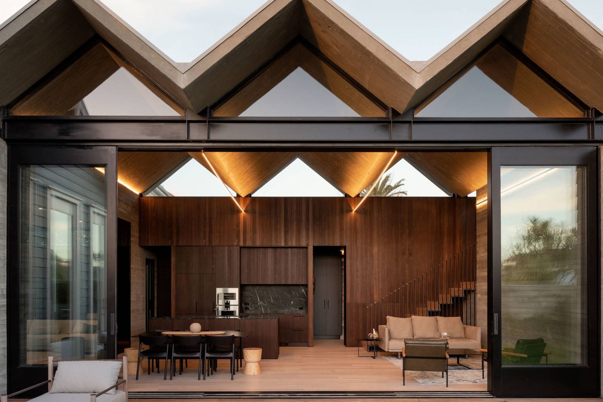 Looking straight into the open-plan kitchen/dining/living area from the backyard. The door in the middle leads down a corridor to the entrance off Douglas Street.