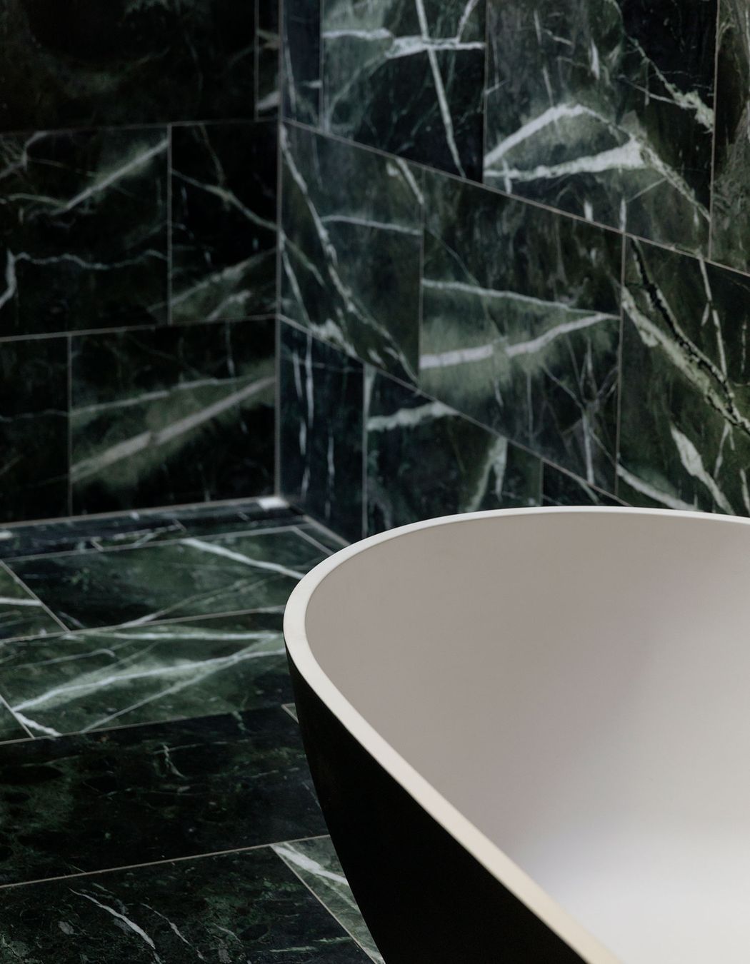 The ensuite bathroom is lined in marble.