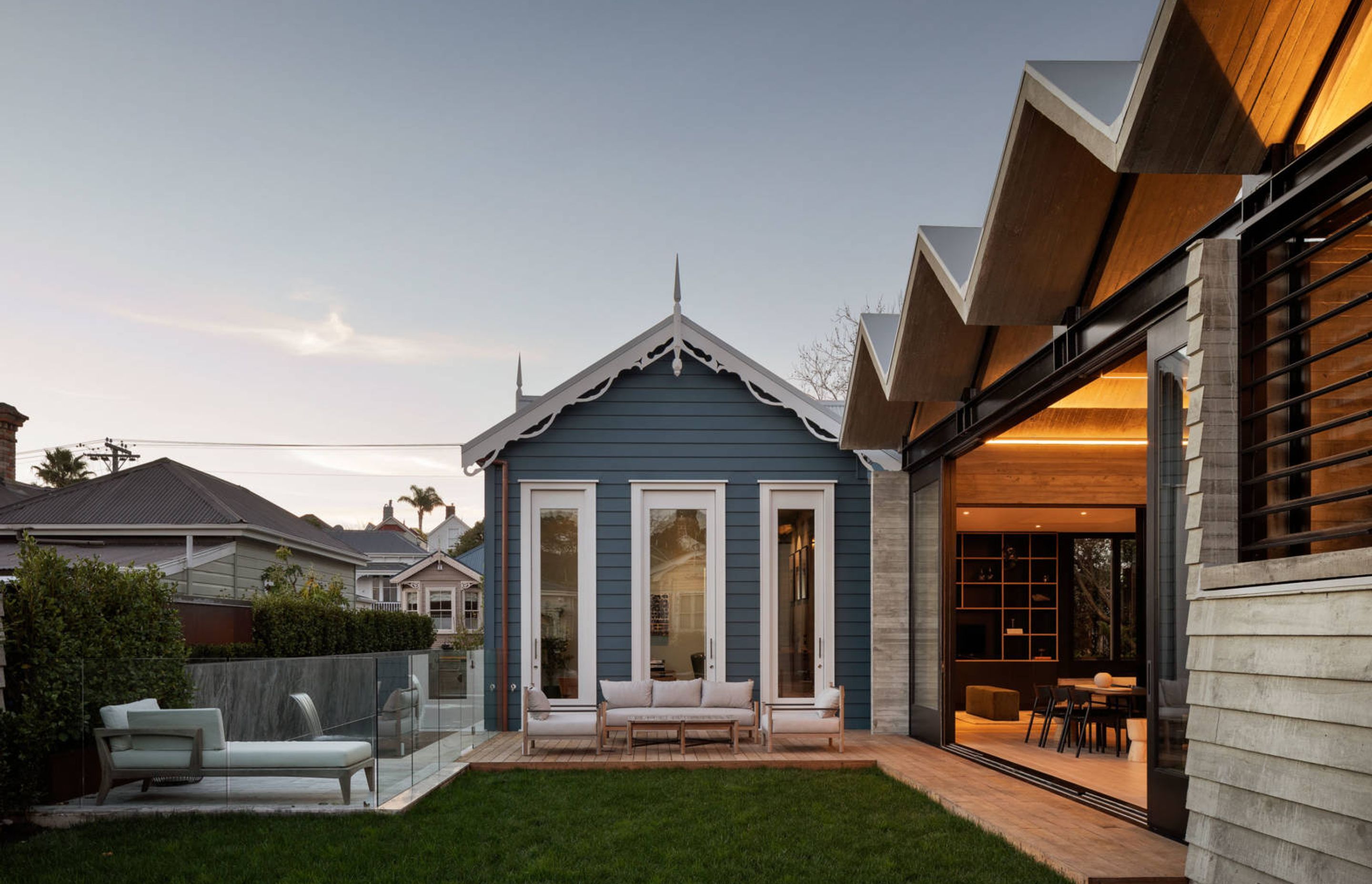 A gable form in the original villa is sandwiched between the lap pool and lounging area and the concrete form of the new northwest-facing extension.