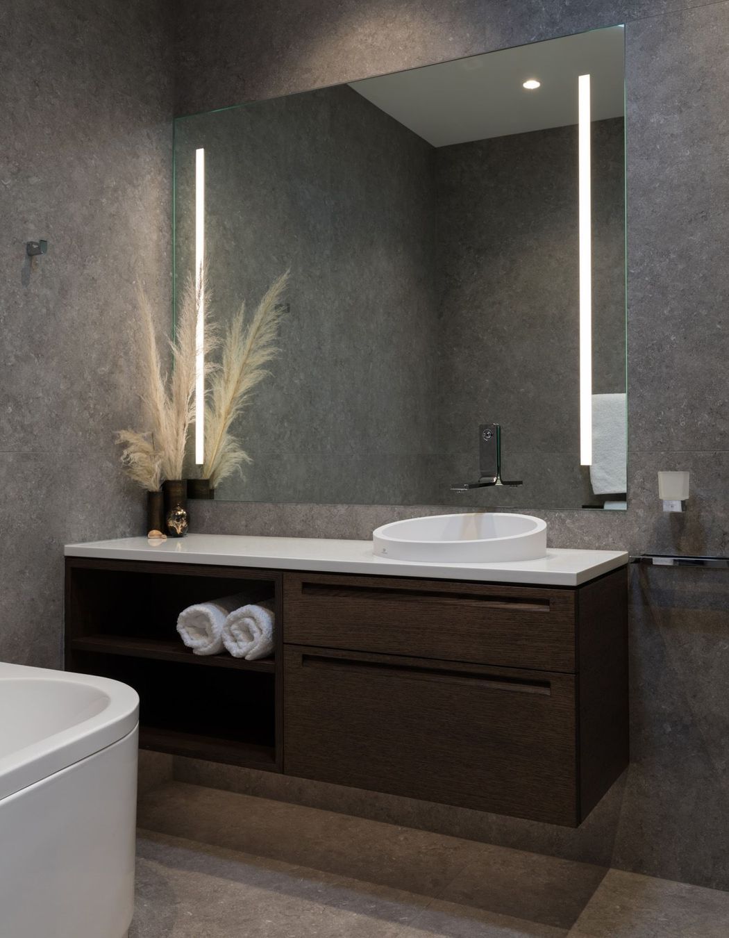 Natural tones fill this bathroom accented by built-in LED strip lights.