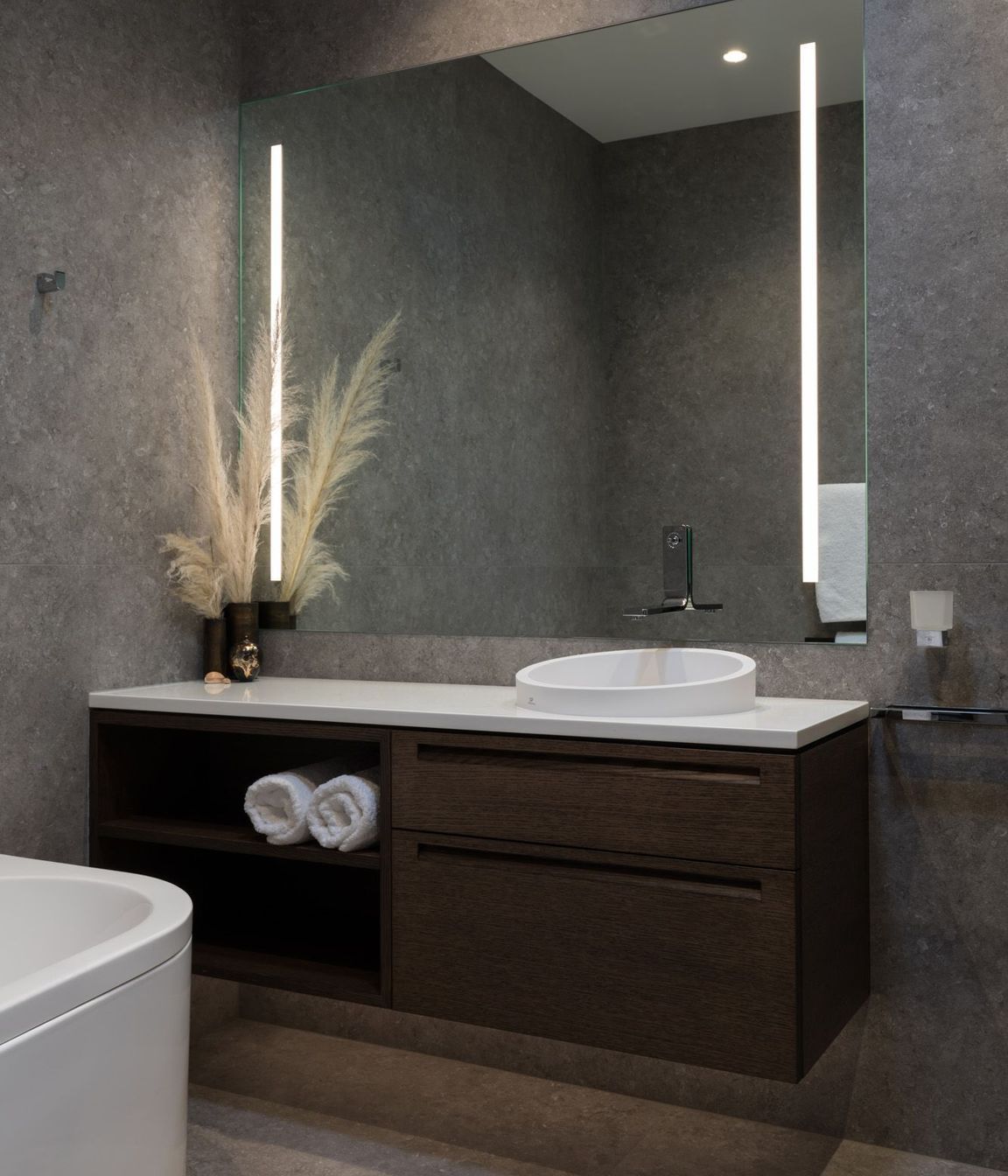 Natural tones fill this bathroom accented by built-in LED strip lights.