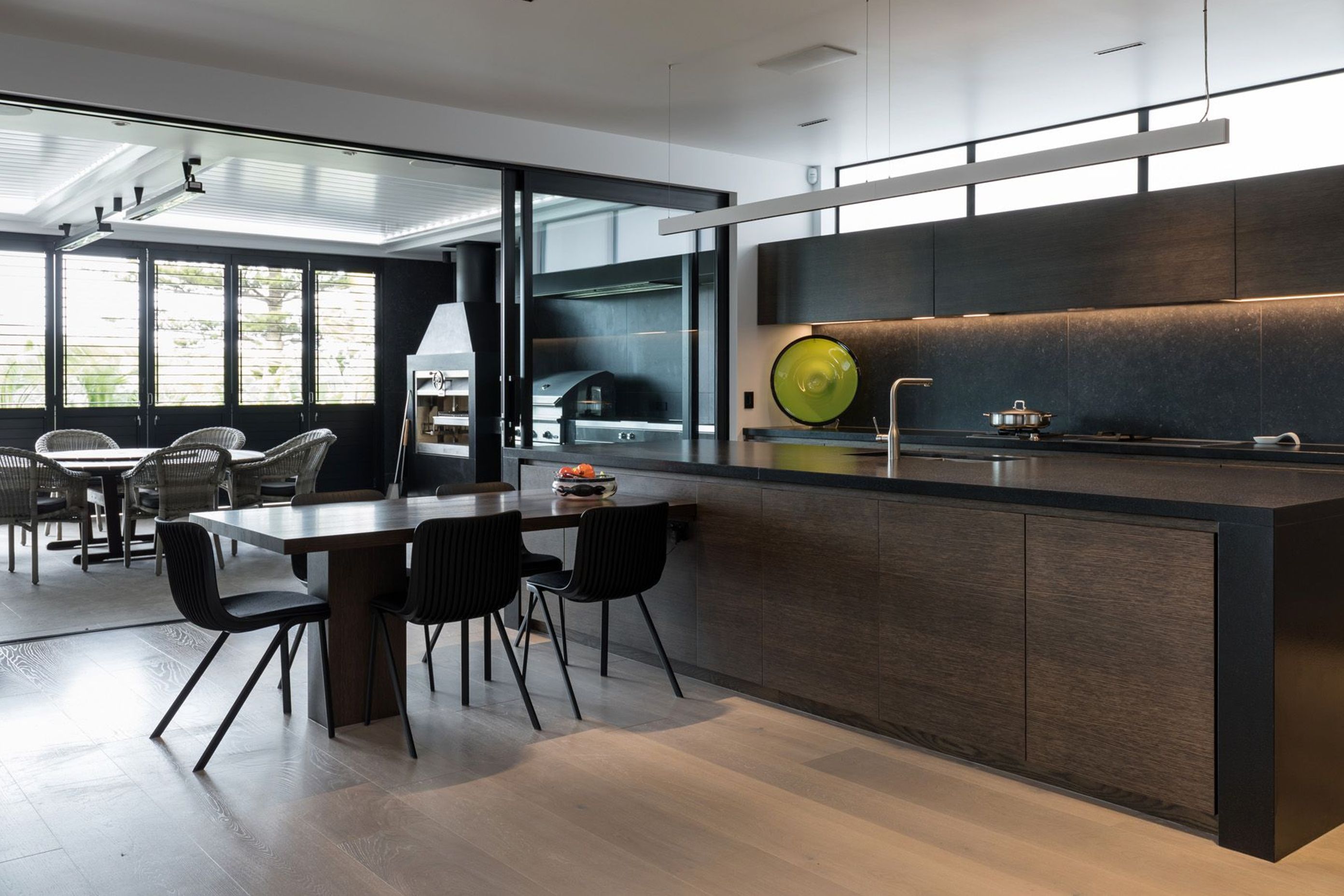 The kitchen is a highly practical arrangement that has clerestory windows over the top of the upper cupboards to draw natural light into the space.