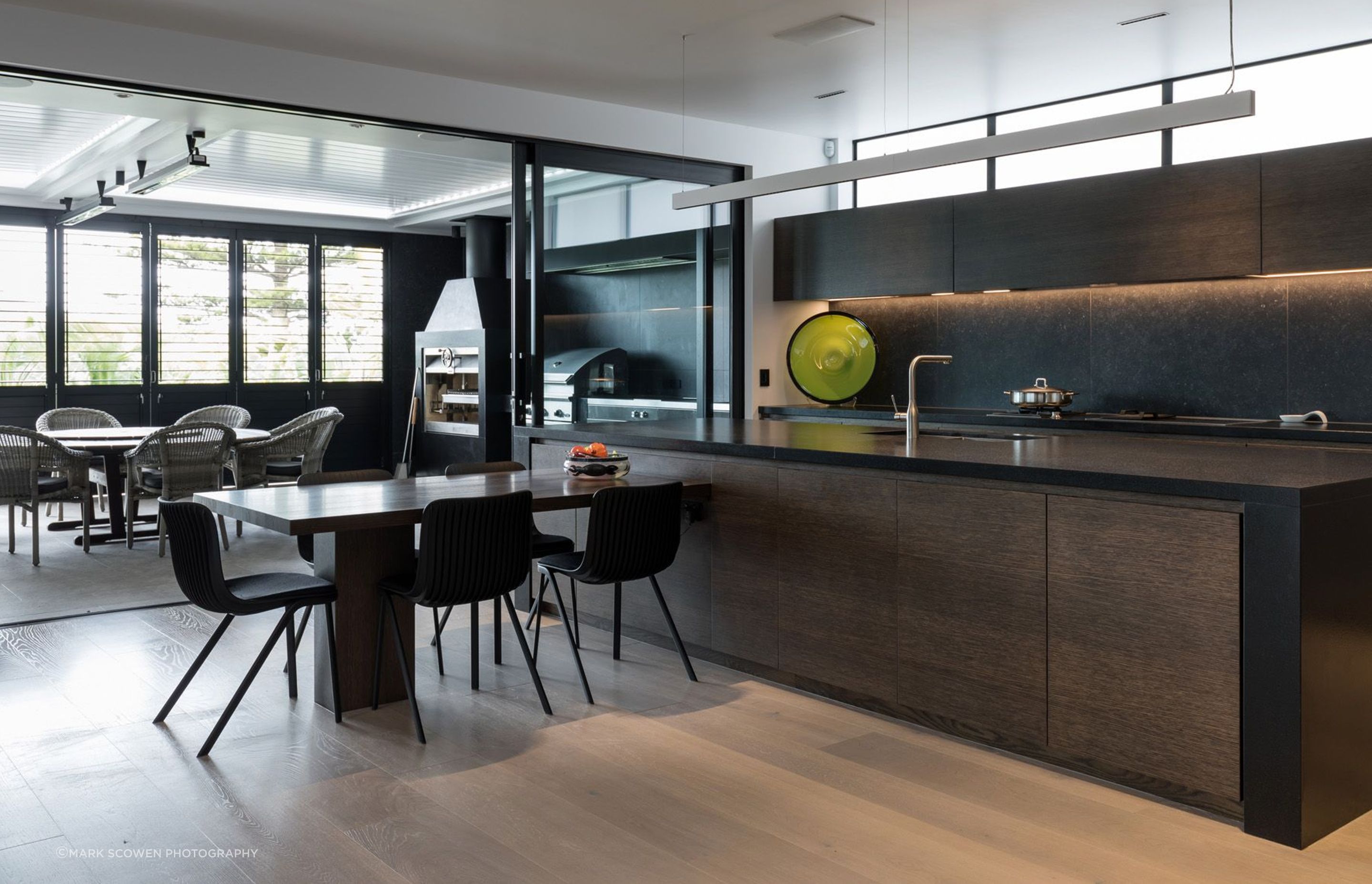 The kitchen is a highly practical arrangement that has clerestory windows over the top of the upper cupboards to draw natural light into the space.