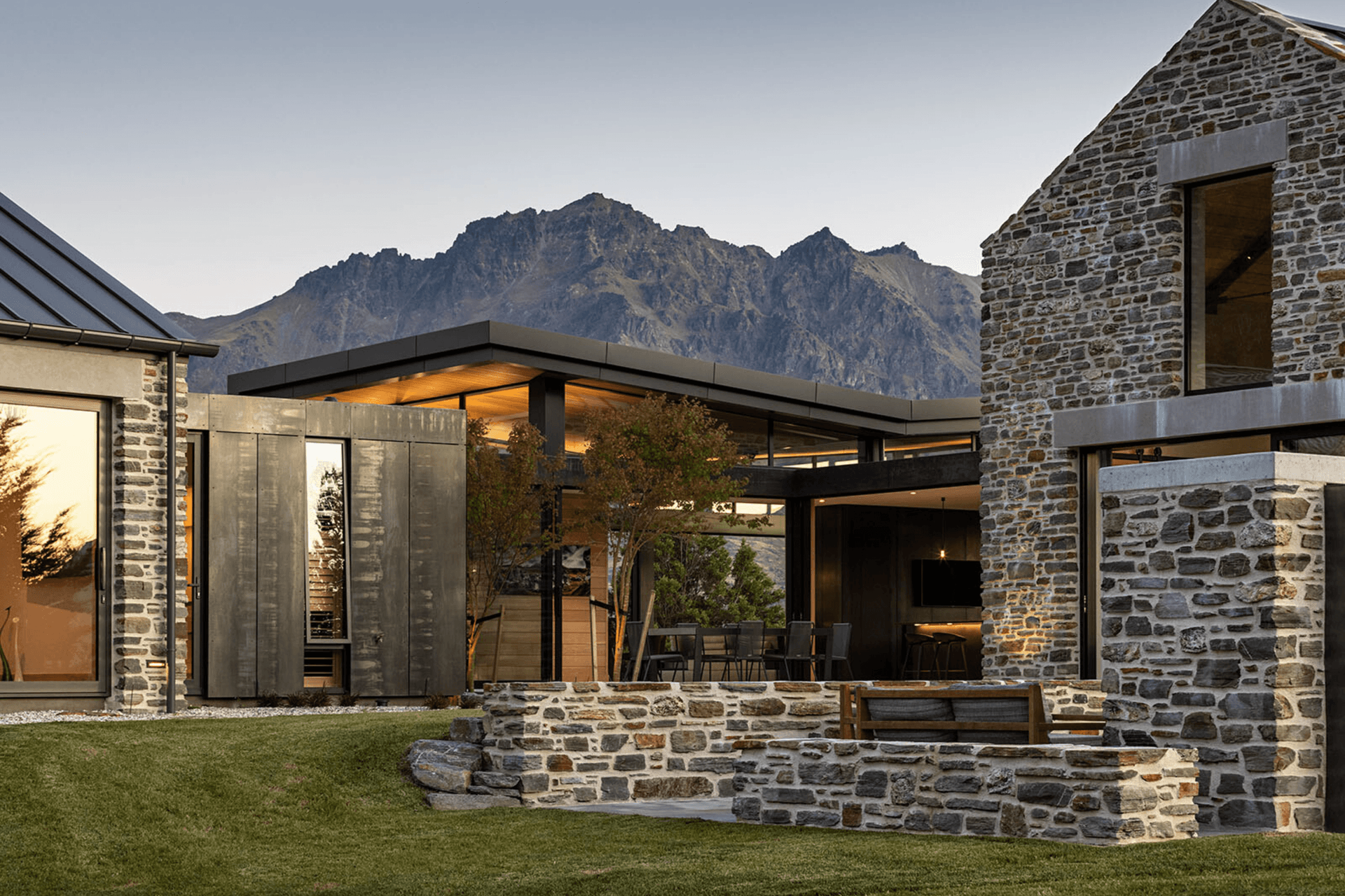 The schist external walls become internal walls within the interconnecting glazed pavilions.