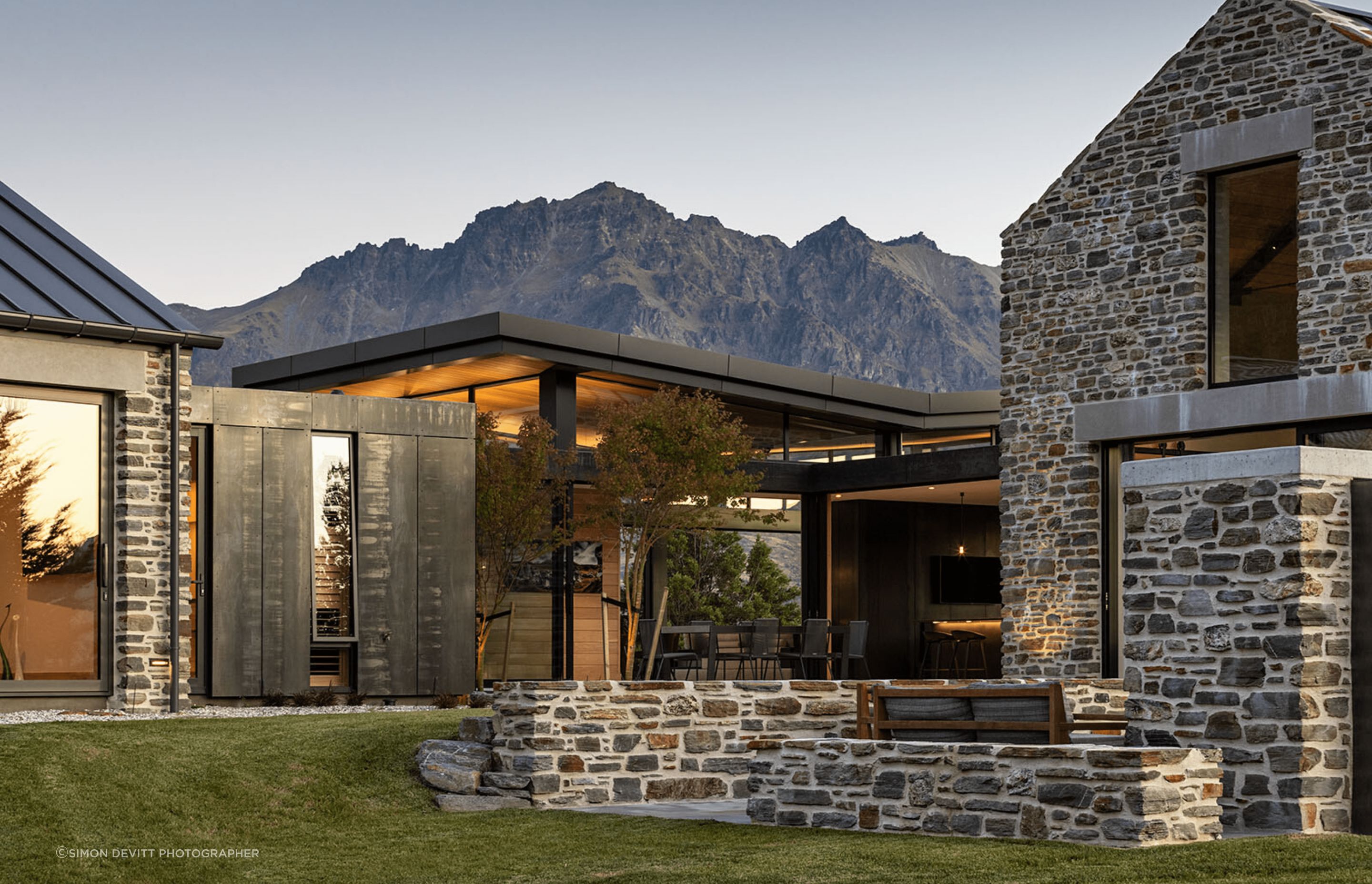 The schist external walls become internal walls within the interconnecting glazed pavilions.