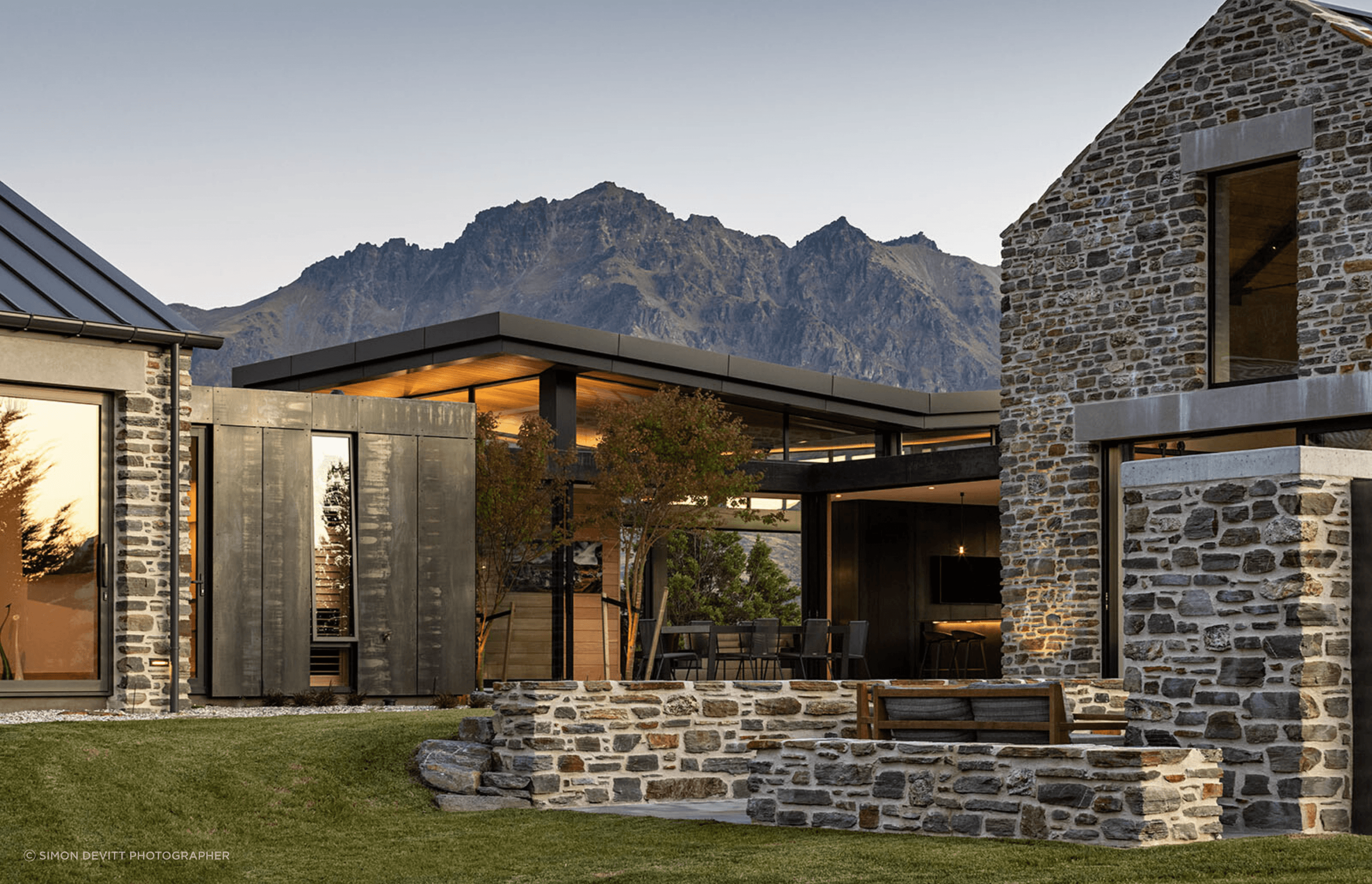 The schist external walls become internal walls within the interconnecting glazed pavilions.
