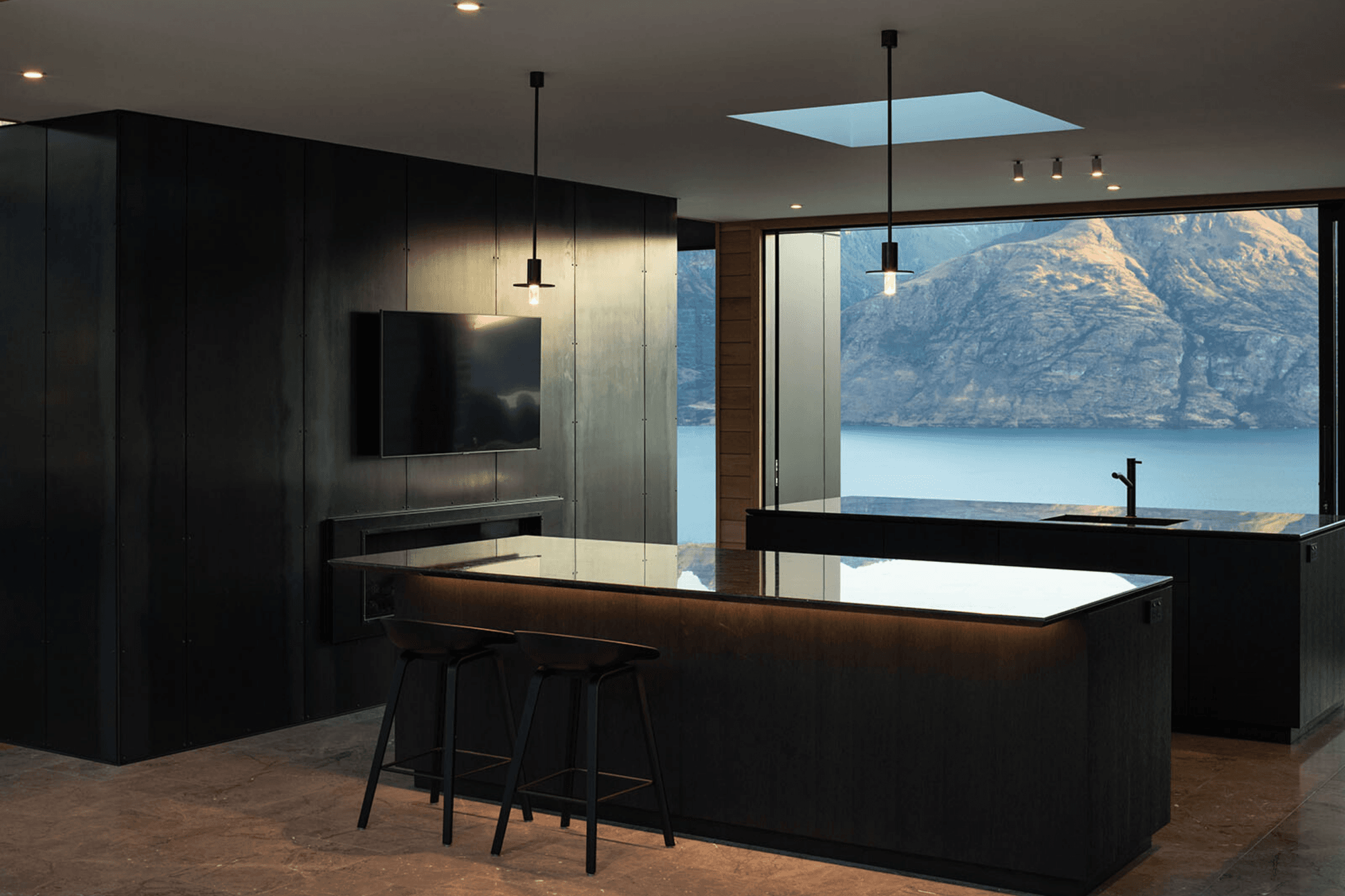 On either side of the kitchen are glass sliders that feature stunning views of the lake on one side, and the mountains on the other.