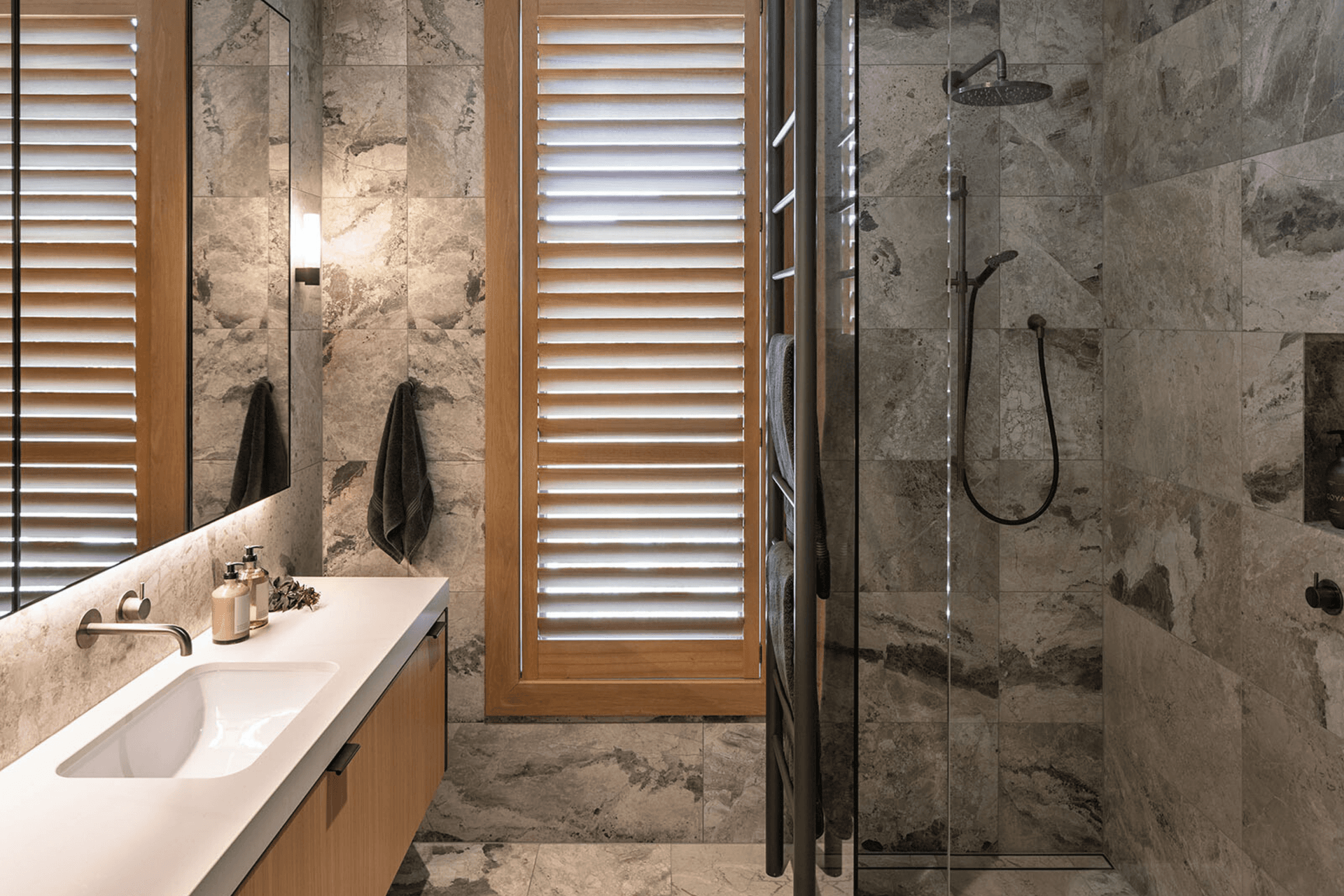 The guest bathrooms are lighter and more neutral than the master bathroom.