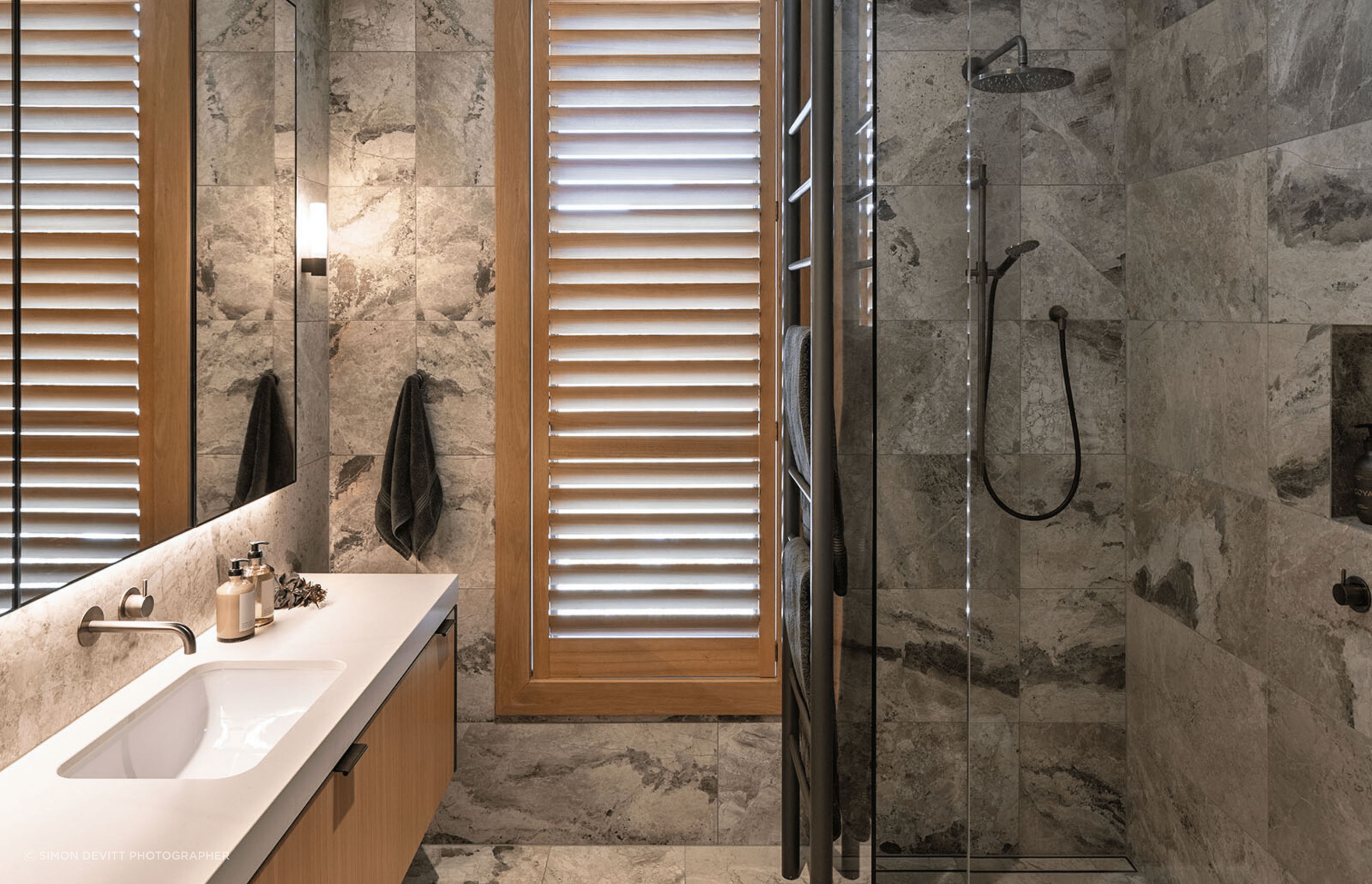 The guest bathrooms are lighter and more neutral than the master bathroom.