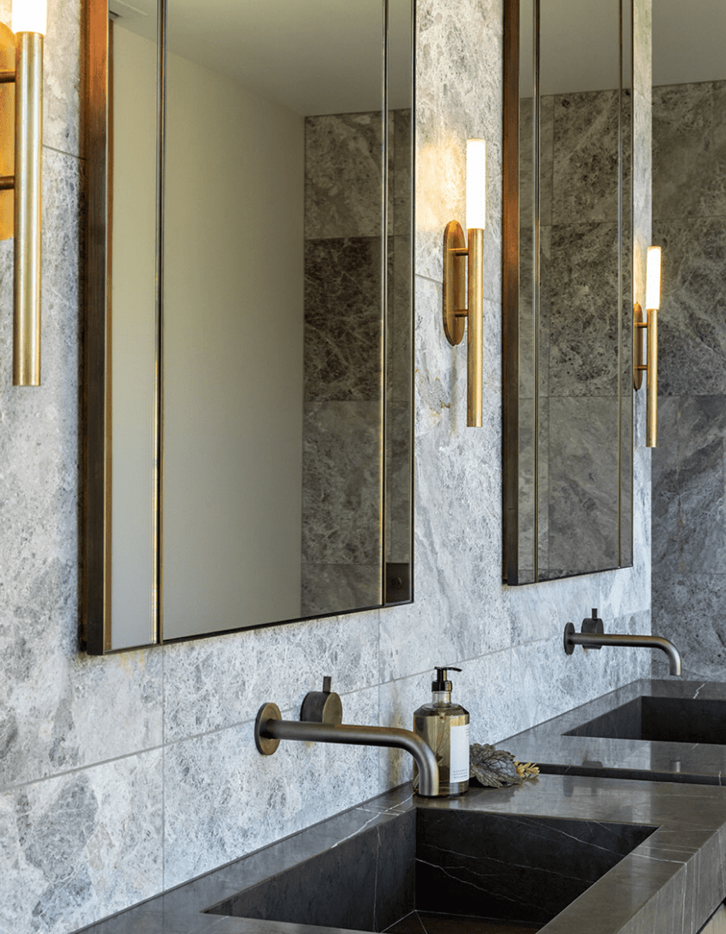 The master en suite has a luxurious feel, with custom vanity and steel accents.