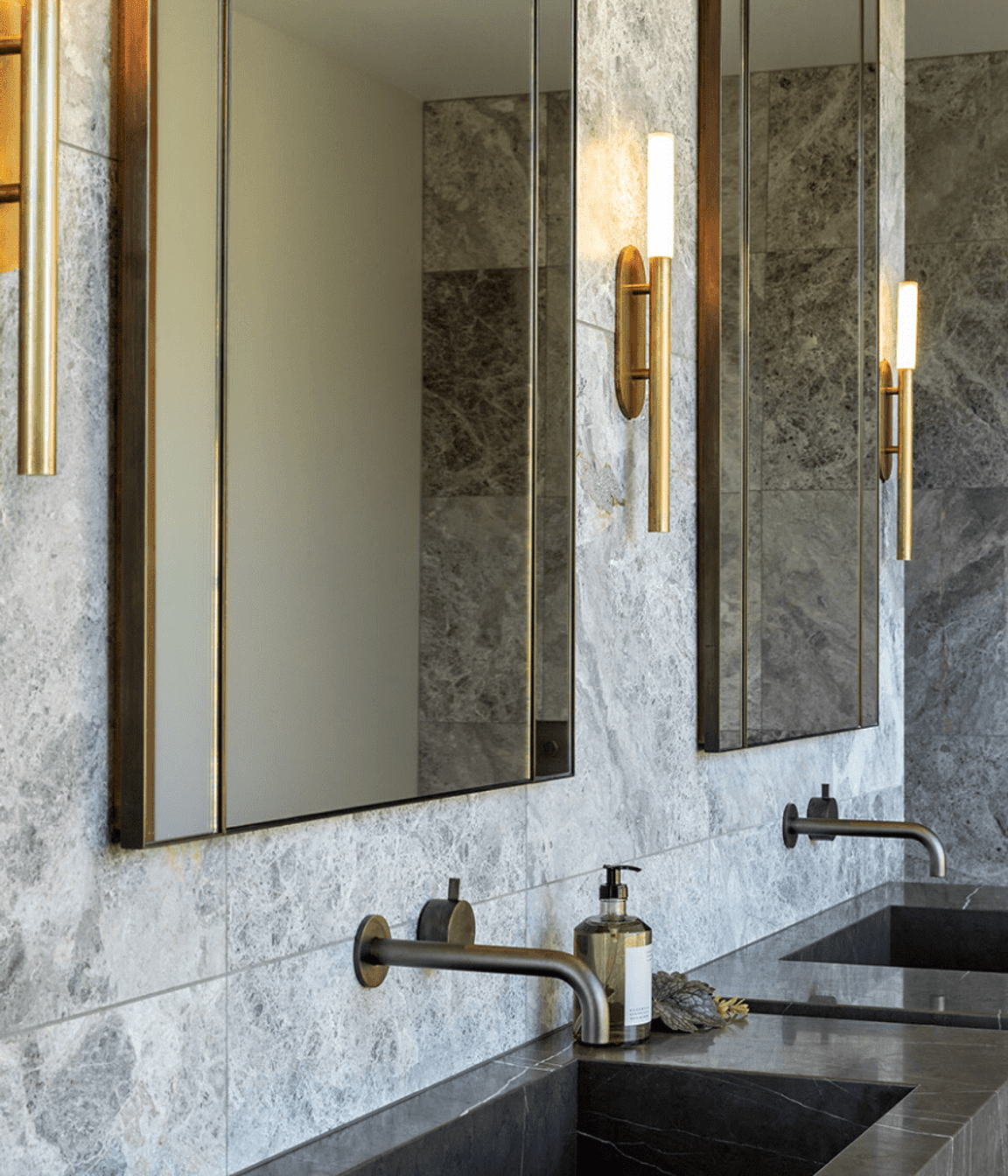 The master en suite has a luxurious feel, with custom vanity and steel accents.