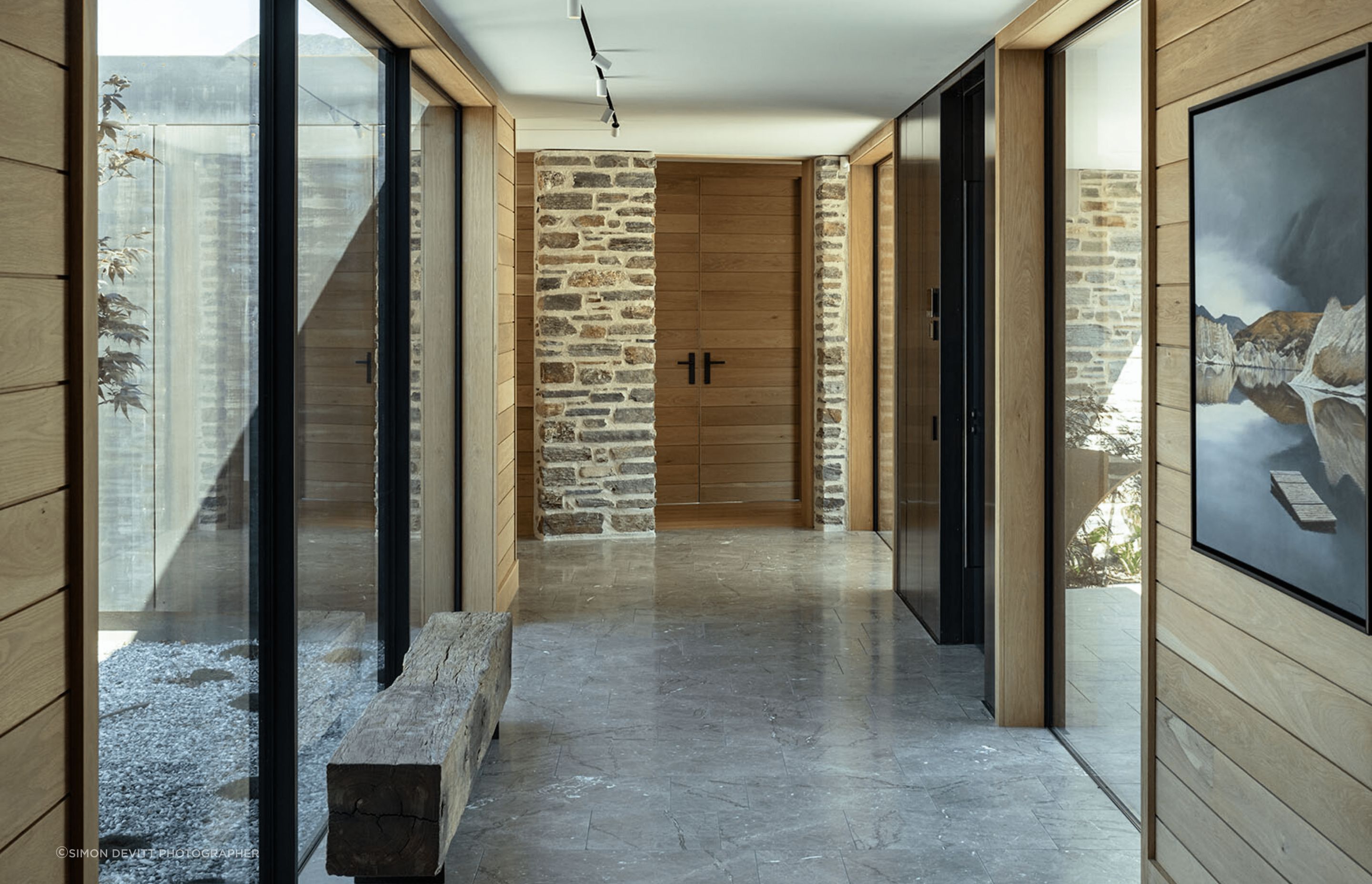 'Baltic' grey marble floors in the transitional areas ground the spaces and enhance the tactile and raw feel.