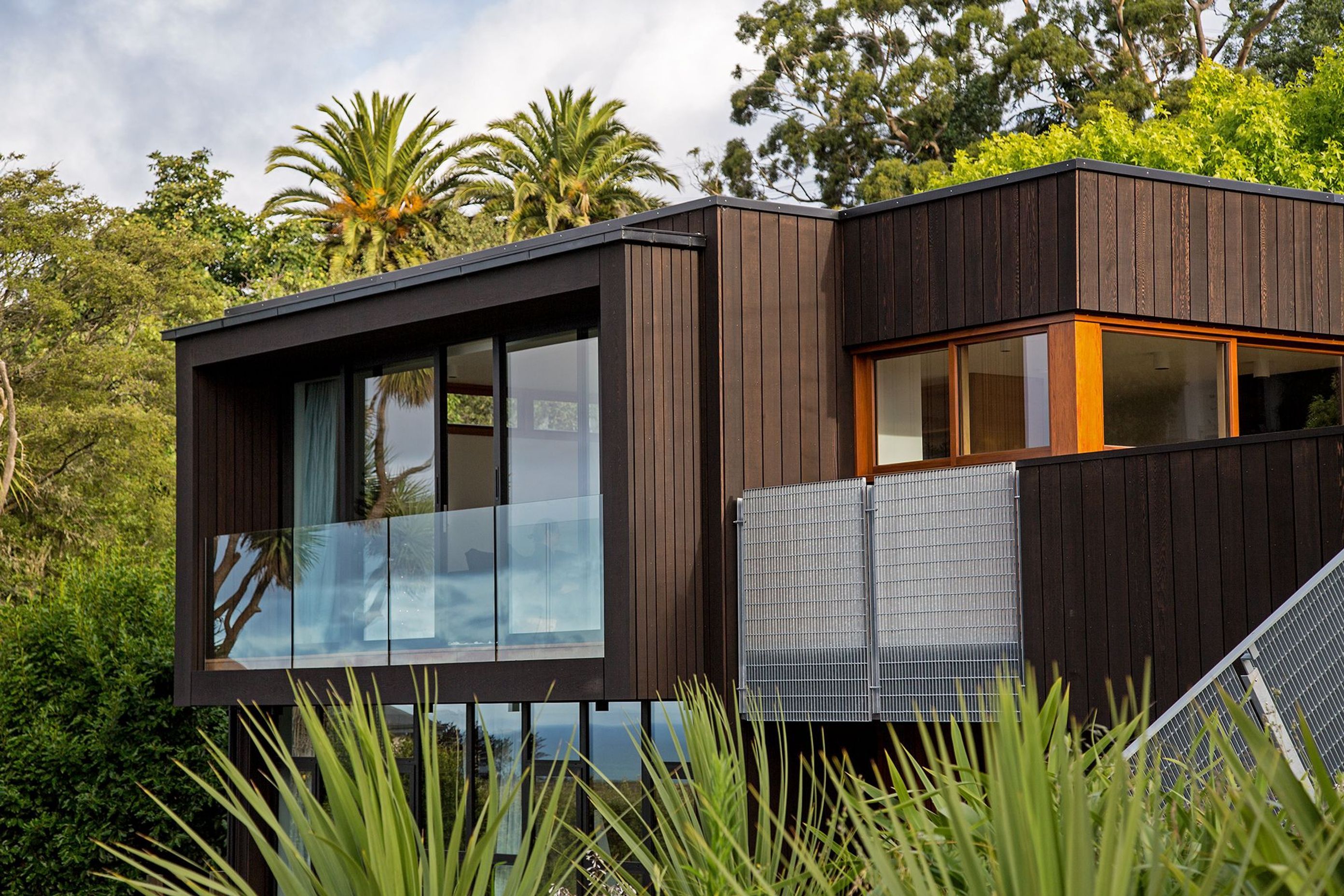 Vertical cedar shiplap frames the new, enclosed balcony. Image copyright Russell Kleyn Photographs.