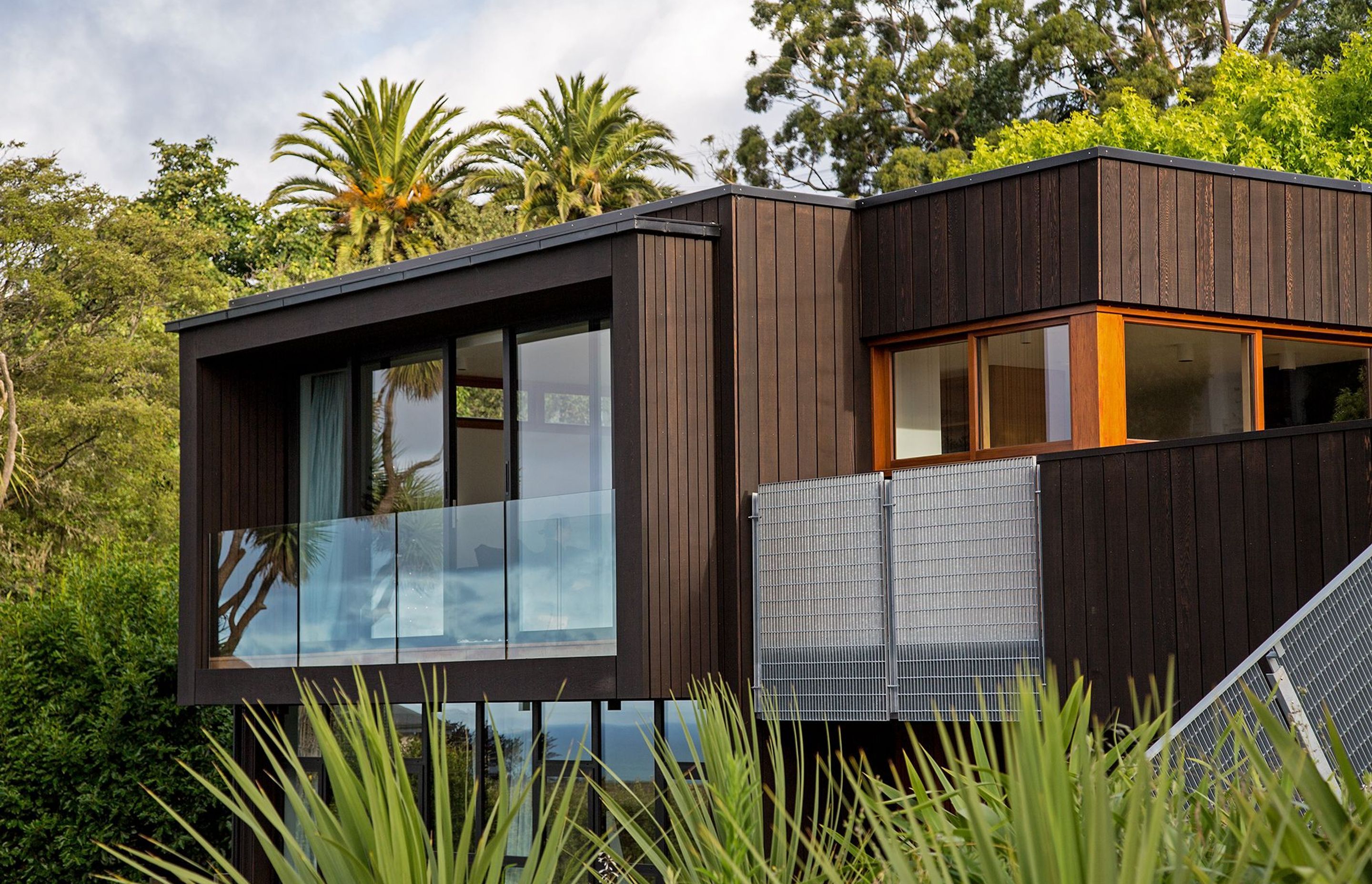 Vertical cedar shiplap frames the new, enclosed balcony. Image copyright Russell Kleyn Photographs.