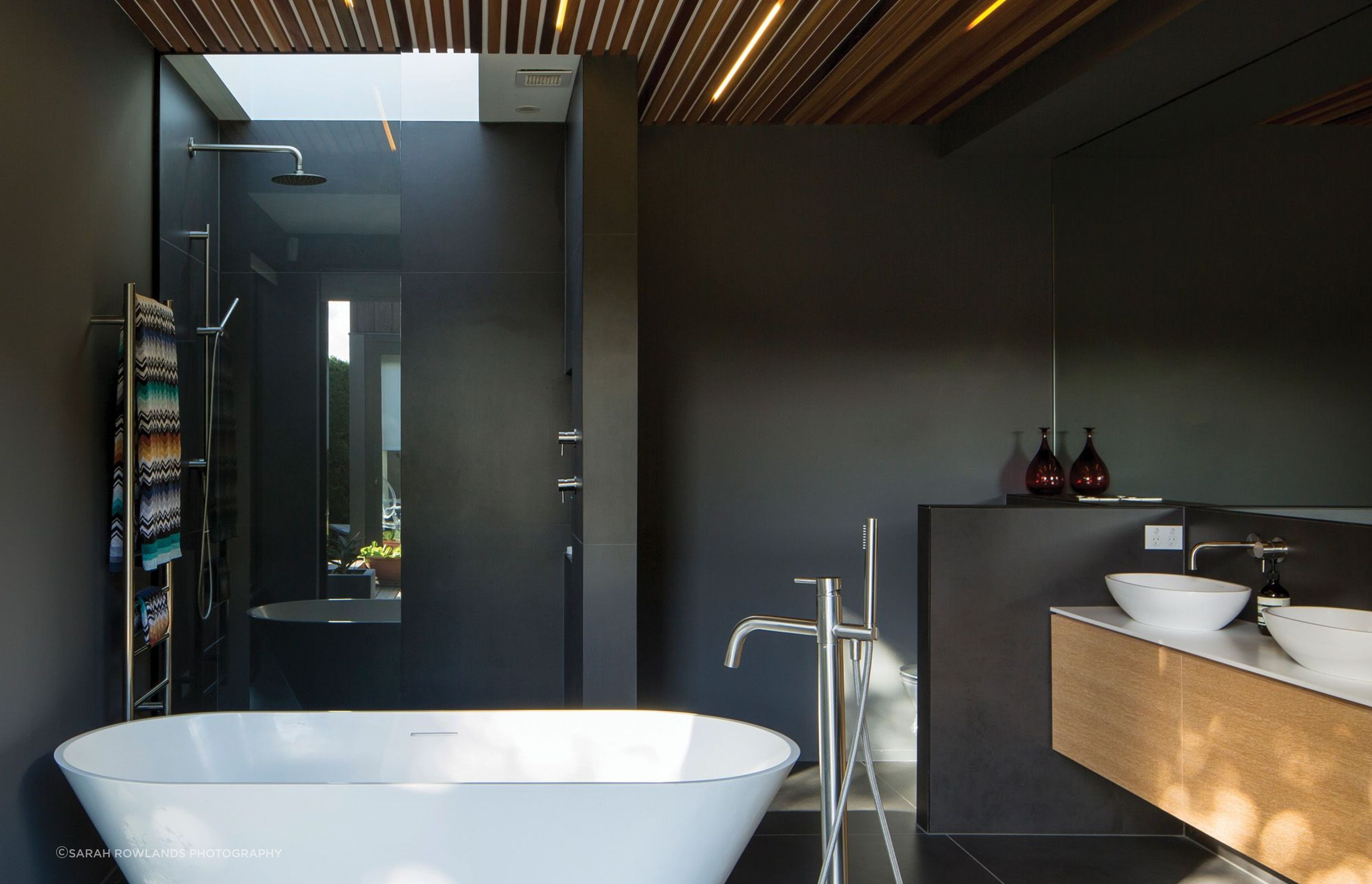 The master ensuite bathroom has a skylight to draw light into the dark interior.