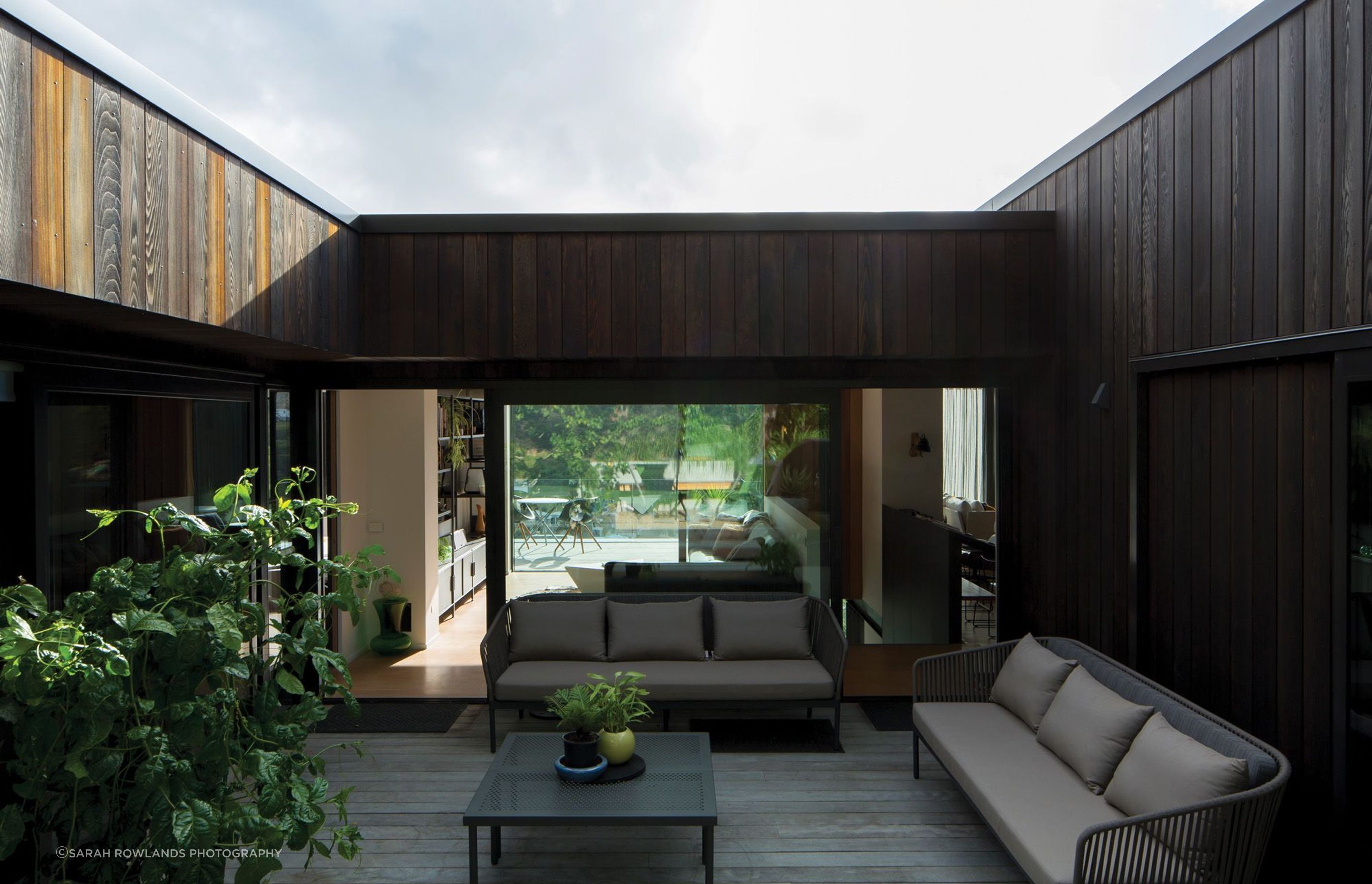 The south-facing central courtyard space is connected to the snug and the view, with the guest bedroom suite through sliding doors to the right.