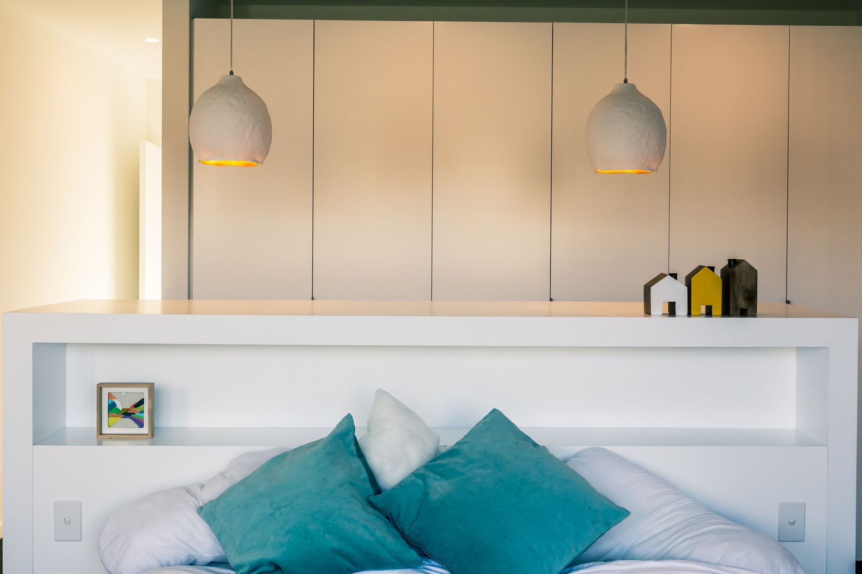 A pared-back colour scheme in the main bedroom keeps the feeling light and fresh.
