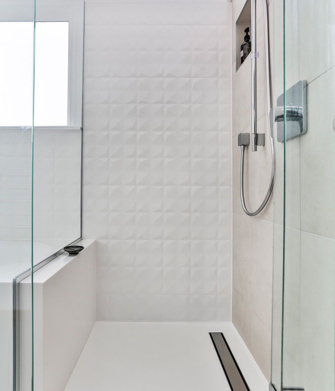 The stream-lined junction between the shower and the bath create the striking monolithic design and delight the owner with its effortless cleaning.