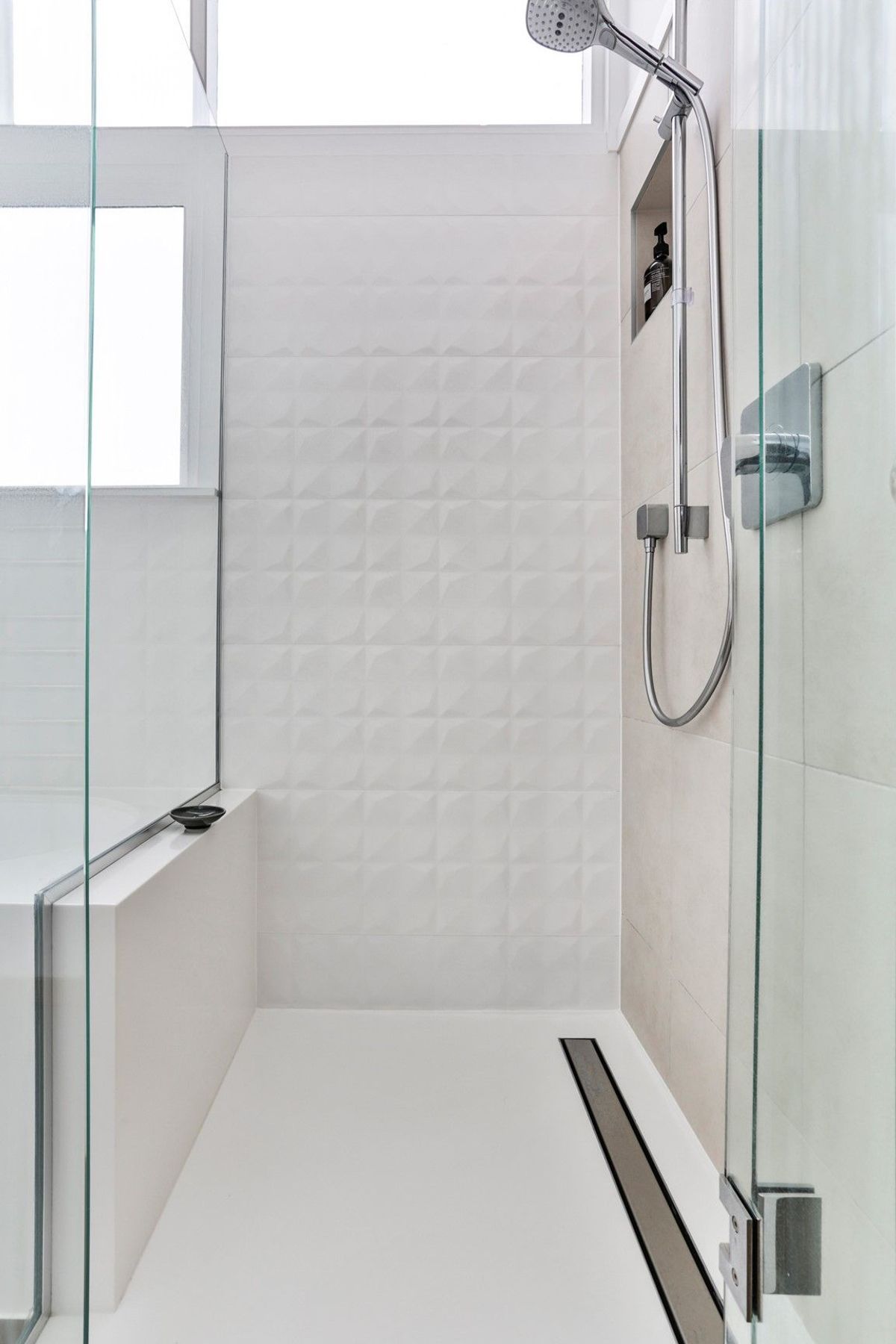 The stream-lined junction between the shower and the bath create the striking monolithic design and delight the owner with its effortless cleaning.