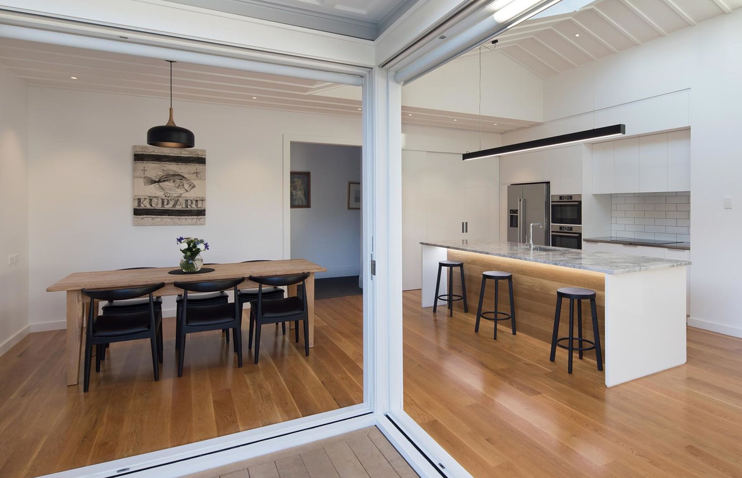 A clean, minimal aesthetic combined with removing internal and external walls realised an bright, open space.