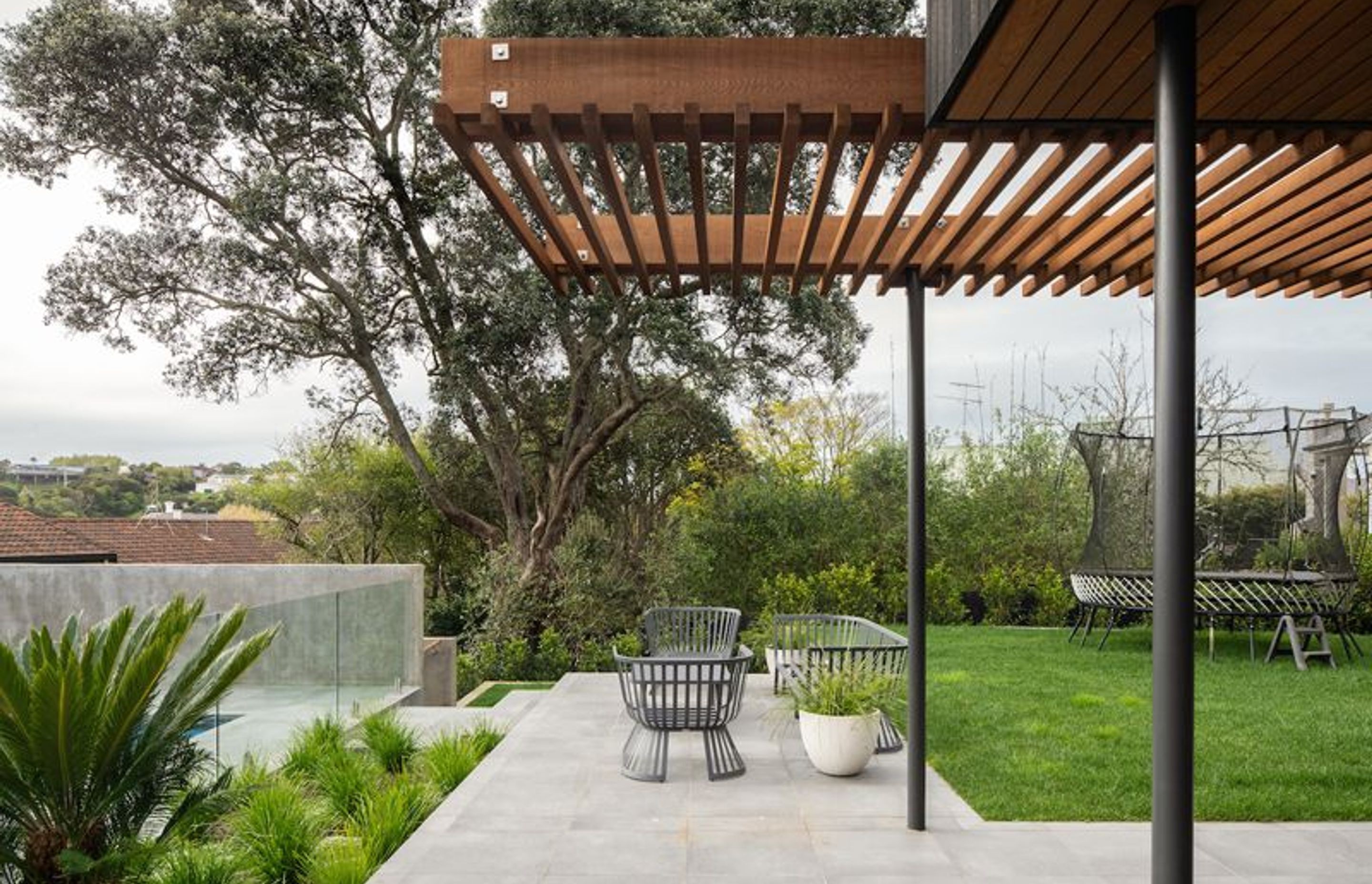 A terraced, landscaped area and pool form the rear, private area of the home. 