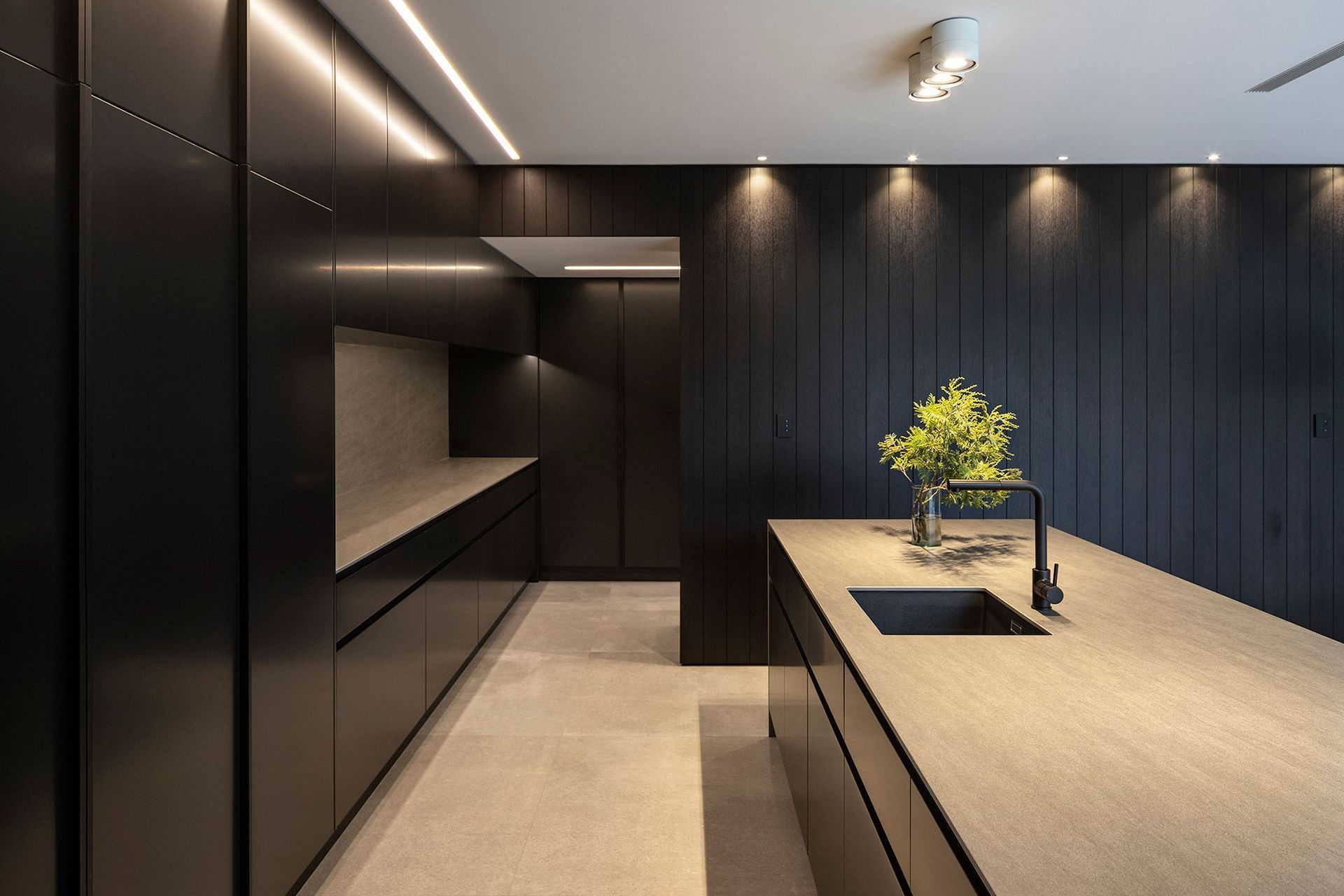 As with the exterior, the interior features a simplified palette of stone and timber.