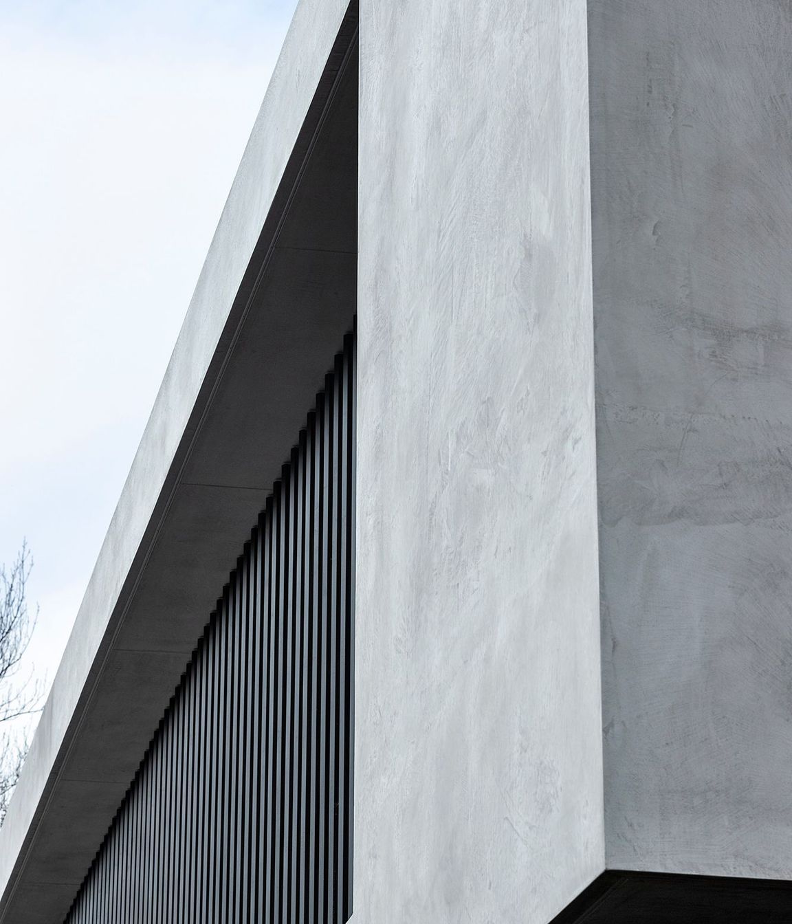 The pared-back material palette serves to reinforce the sense of the house being a stronghold against the encroaching urban environment.