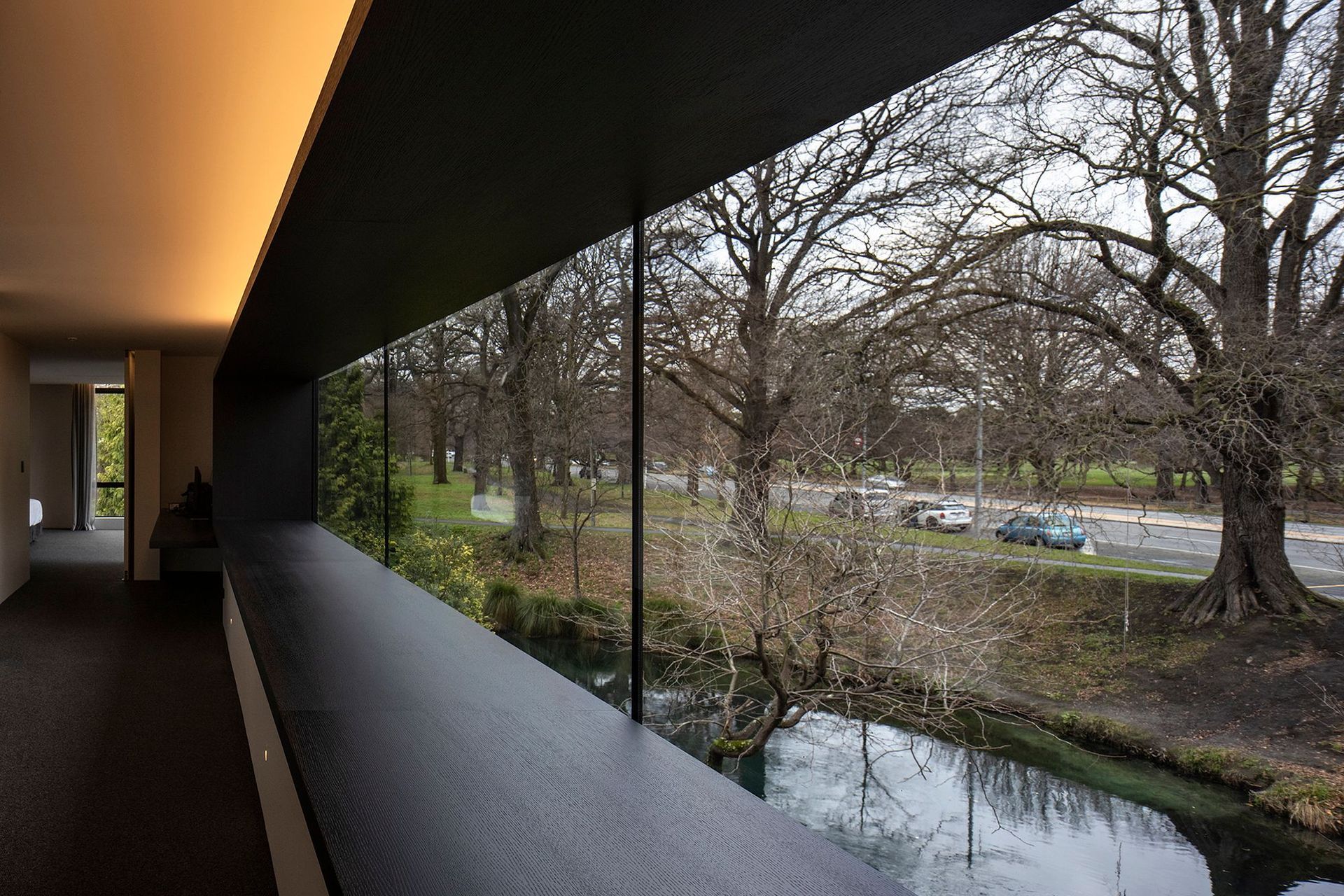 Almost wall-to-wall glazing on the upper level serves to connect the master suite to the river and park beyond.