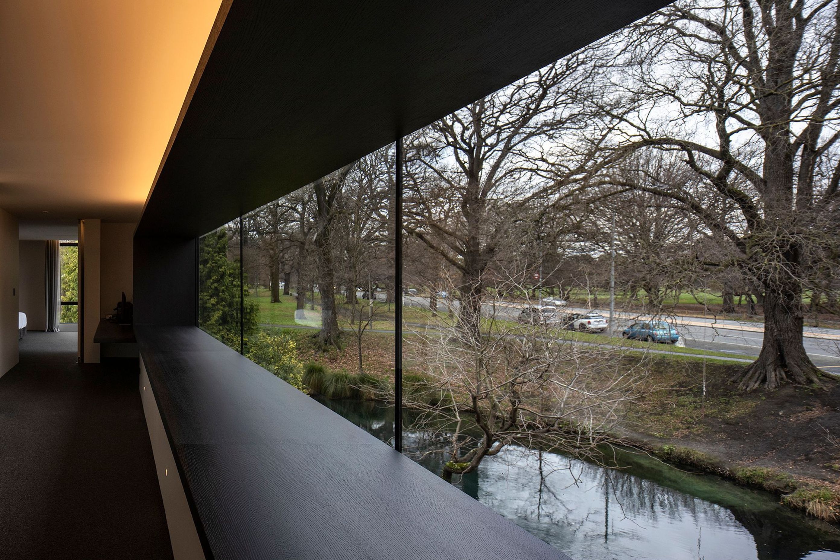 Almost wall-to-wall glazing on the upper level serves to connect the master suite to the river and park beyond.