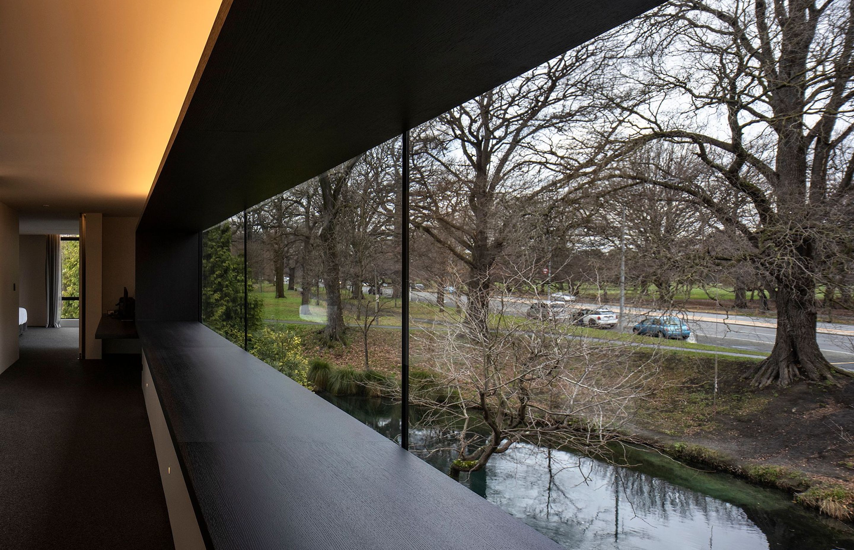 Almost wall-to-wall glazing on the upper level serves to connect the master suite to the river and park beyond.