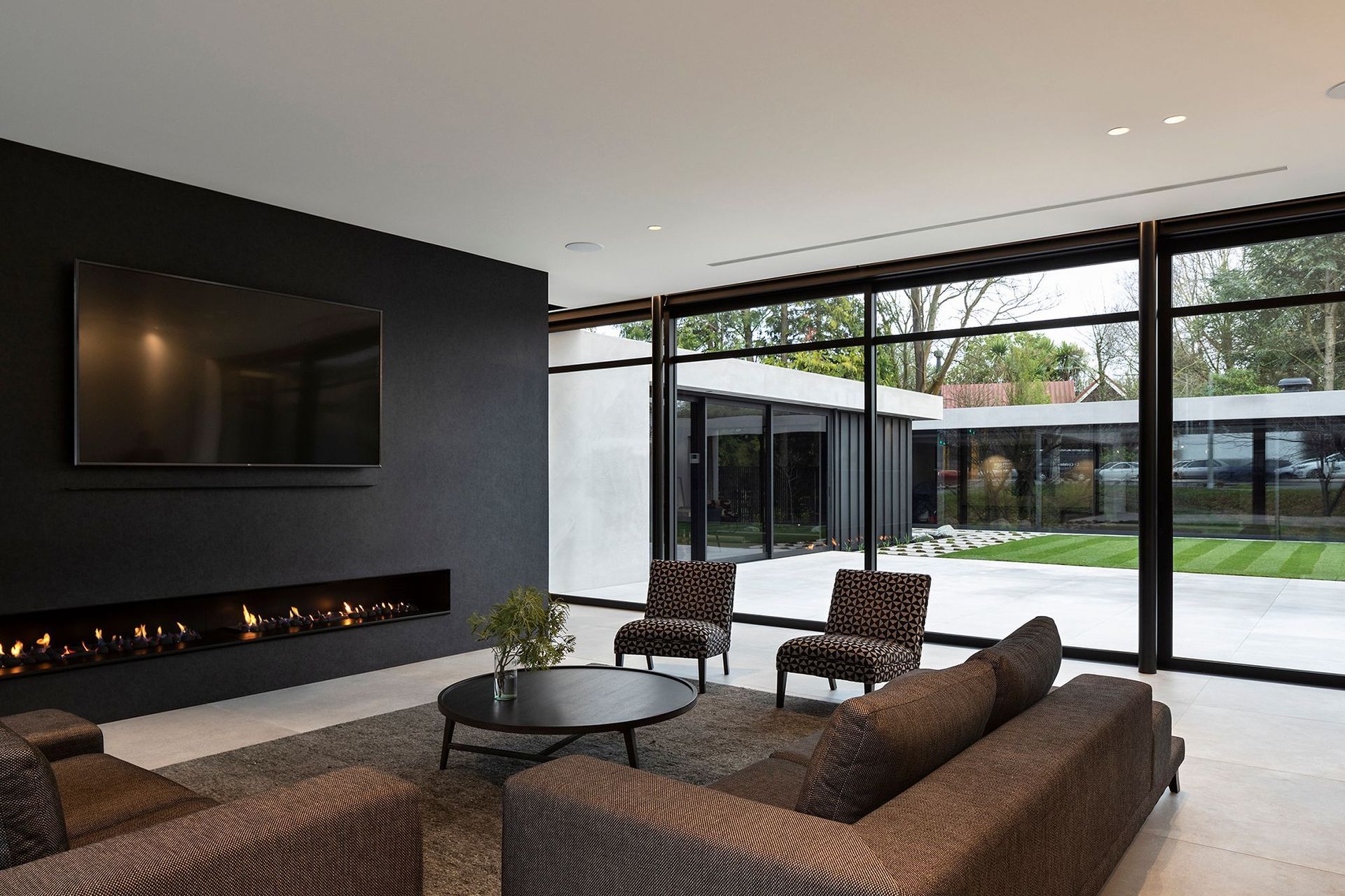 The boundary between indoors and out has been blurred through the seamless use of materials, which creates a smoothly continuous flow from the main living area to the courtyard and separate garden pavilion containing the swimming pool, spa and a change ro