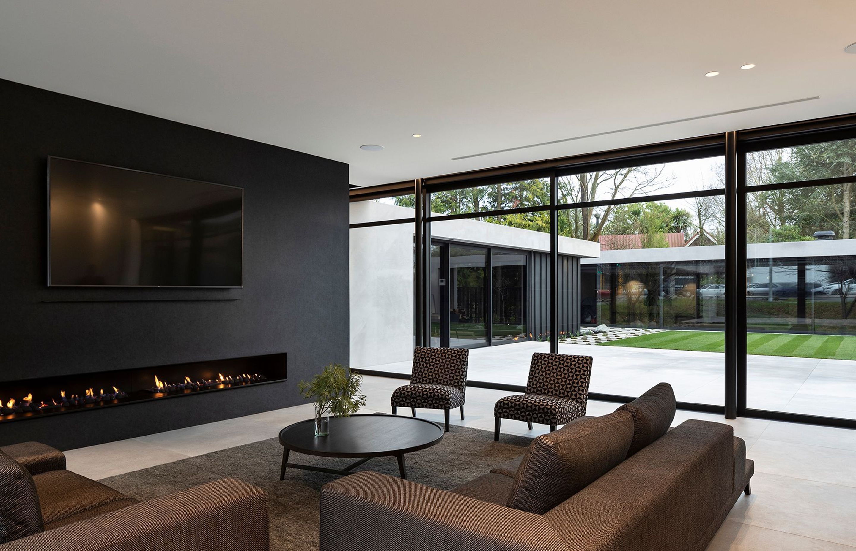 The boundary between indoors and out has been blurred through the seamless use of materials, which creates a smoothly continuous flow from the main living area to the courtyard and separate garden pavilion containing the swimming pool, spa and a change ro