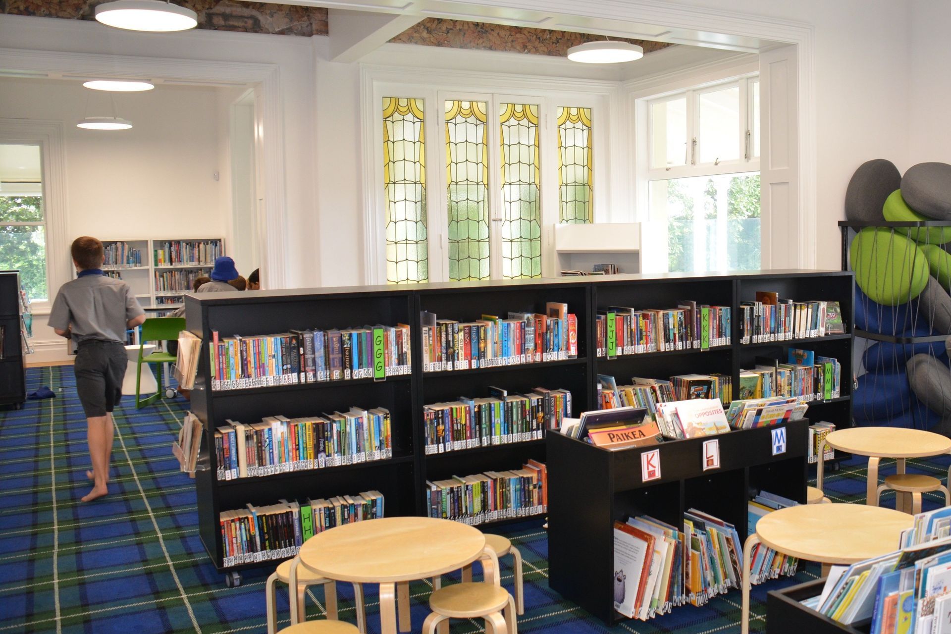 Book shelving can be moved around the heritage space, which retains the stately cornices and stained glass windows.