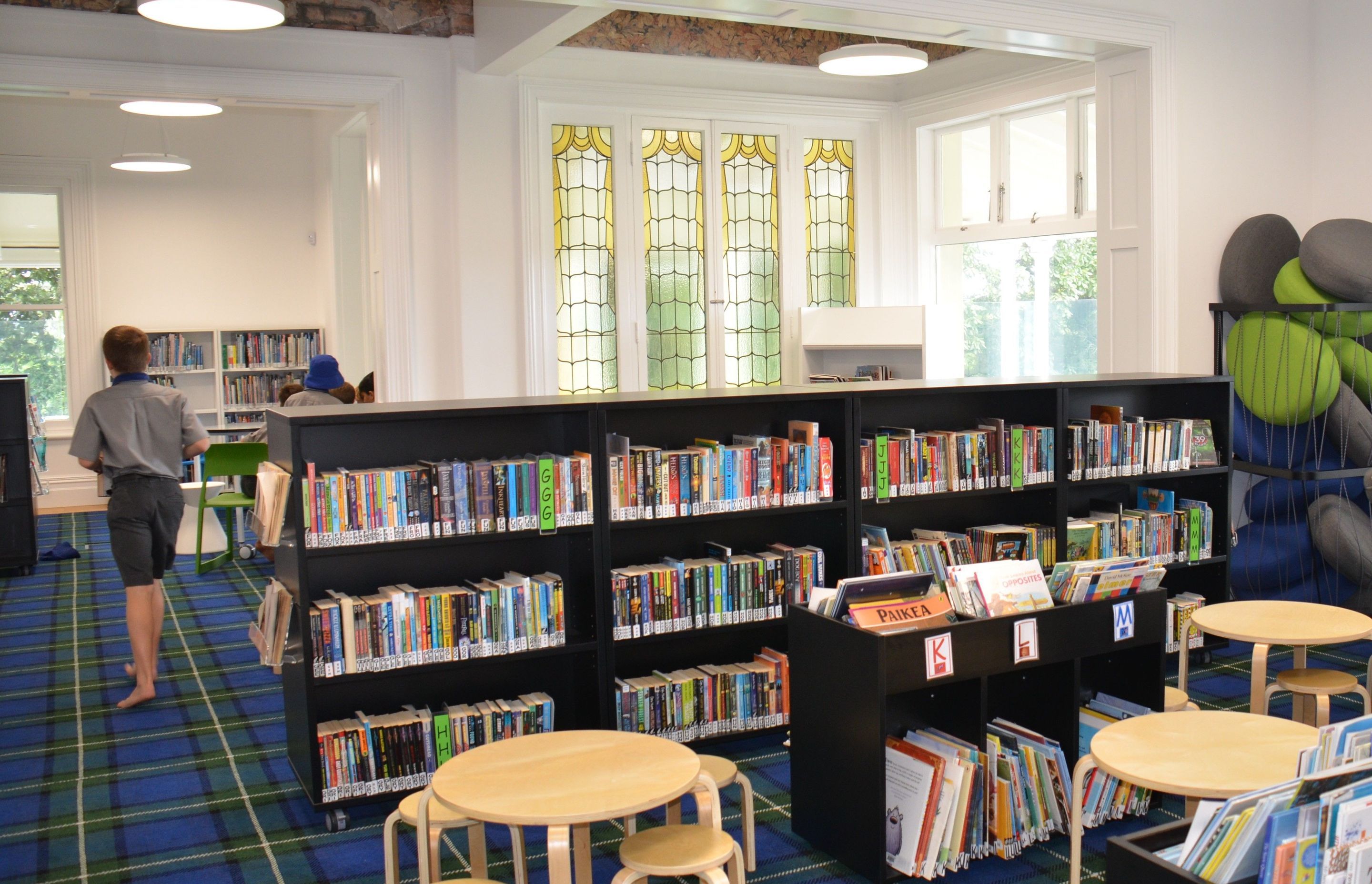 Book shelving can be moved around the heritage space, which retains the stately cornices and stained glass windows.