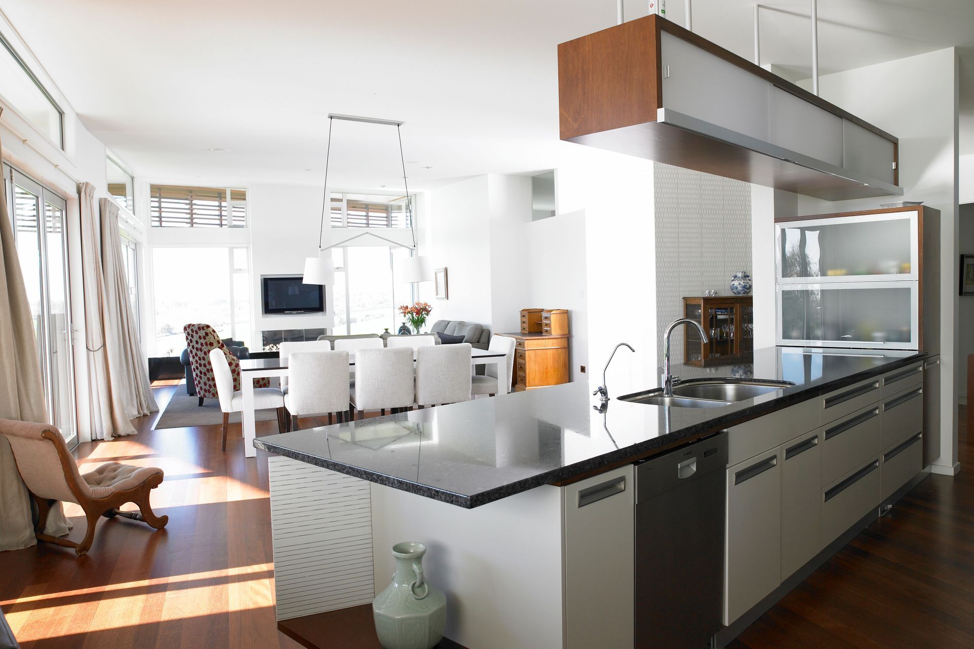 White diffused throughout with this stylish designer kitchen diner. Shapes formed by lighting and furniture pieces.
