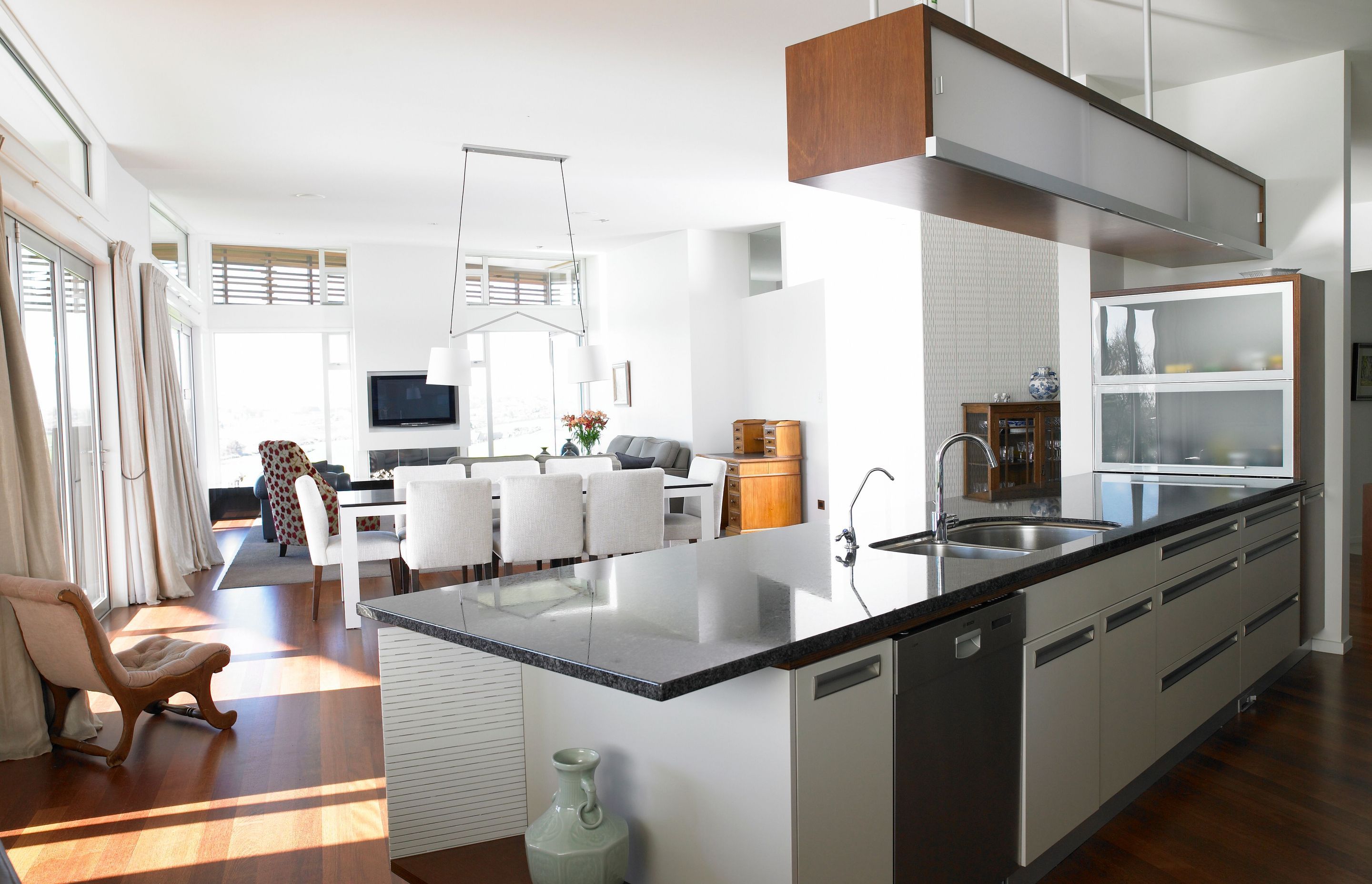 White diffused throughout with this stylish designer kitchen diner. Shapes formed by lighting and furniture pieces.