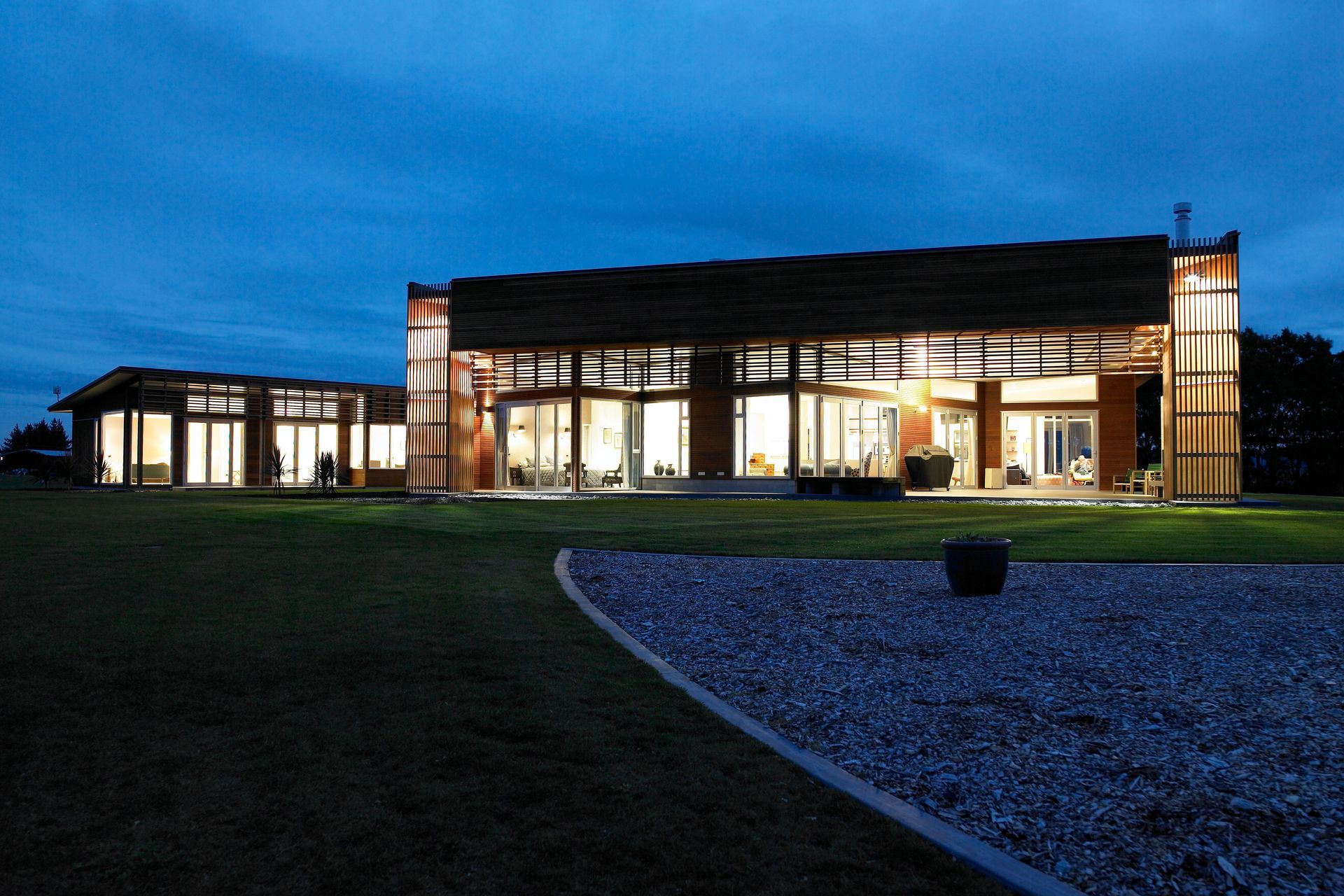White light shines during the blue hour whilst timber creates patterns on the walls.