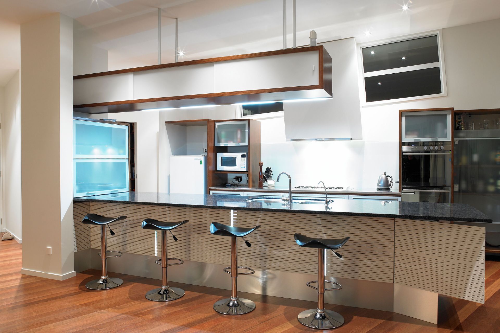 Elegant stools against the textured backdrop.