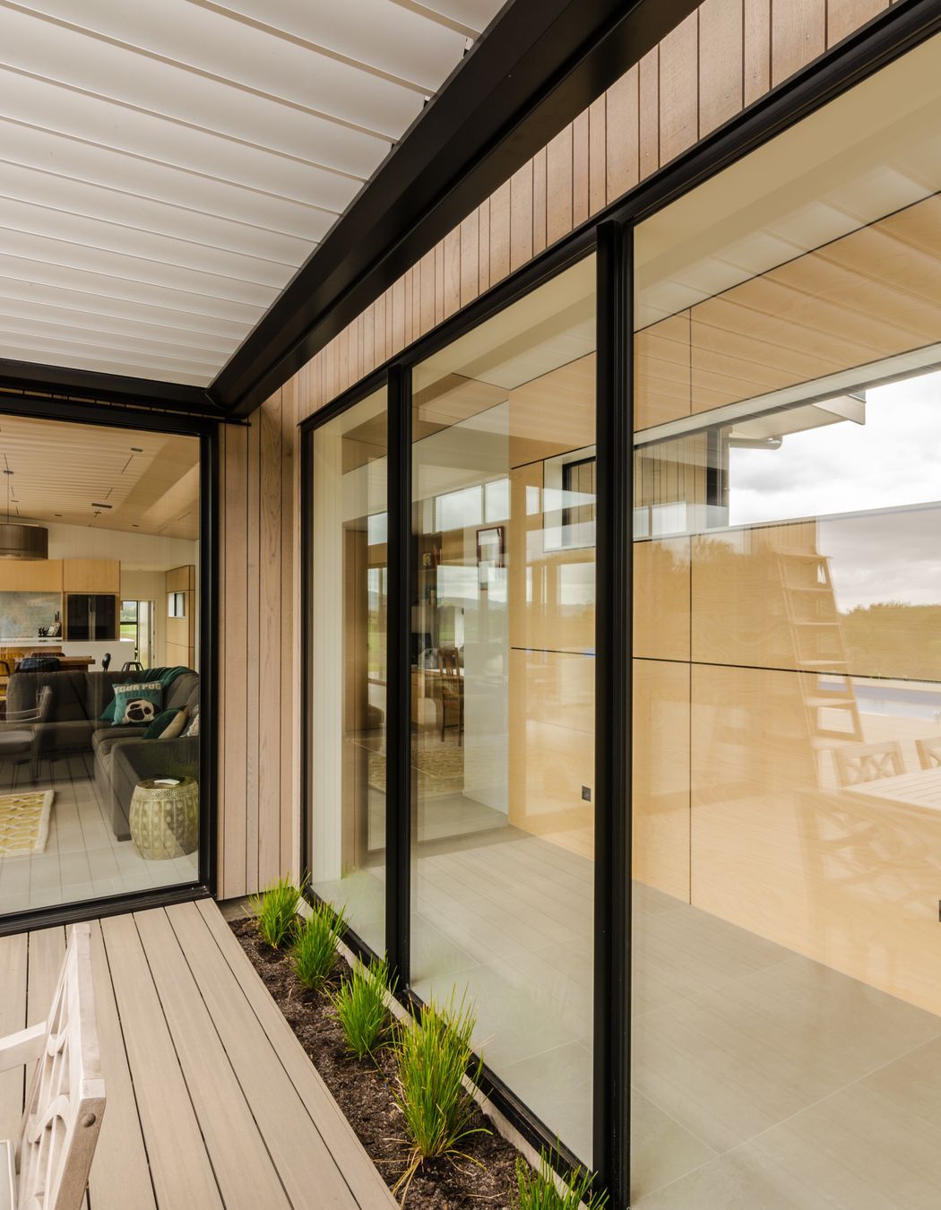The covered outdoor kitchen looks back at the feature ply breezeway.