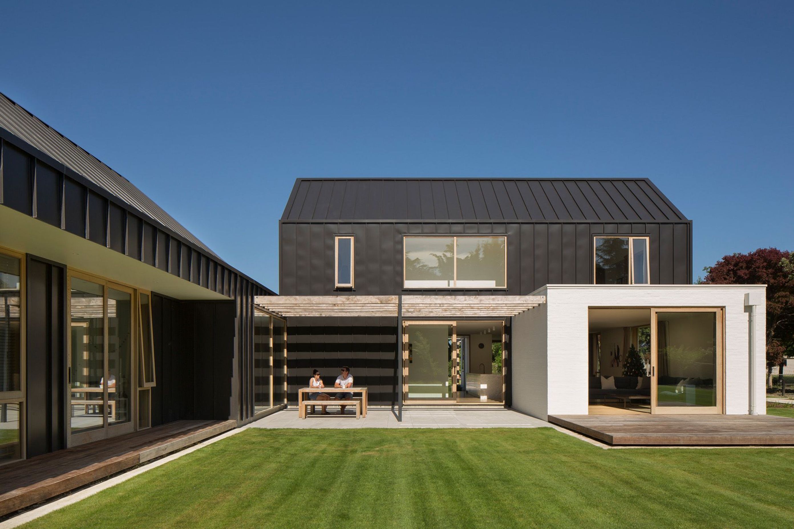 Natural light and shade is carefully controlled throughout this home. Here, a recessive courtyard with a pergola provides shade and shelter from the sun and wind.