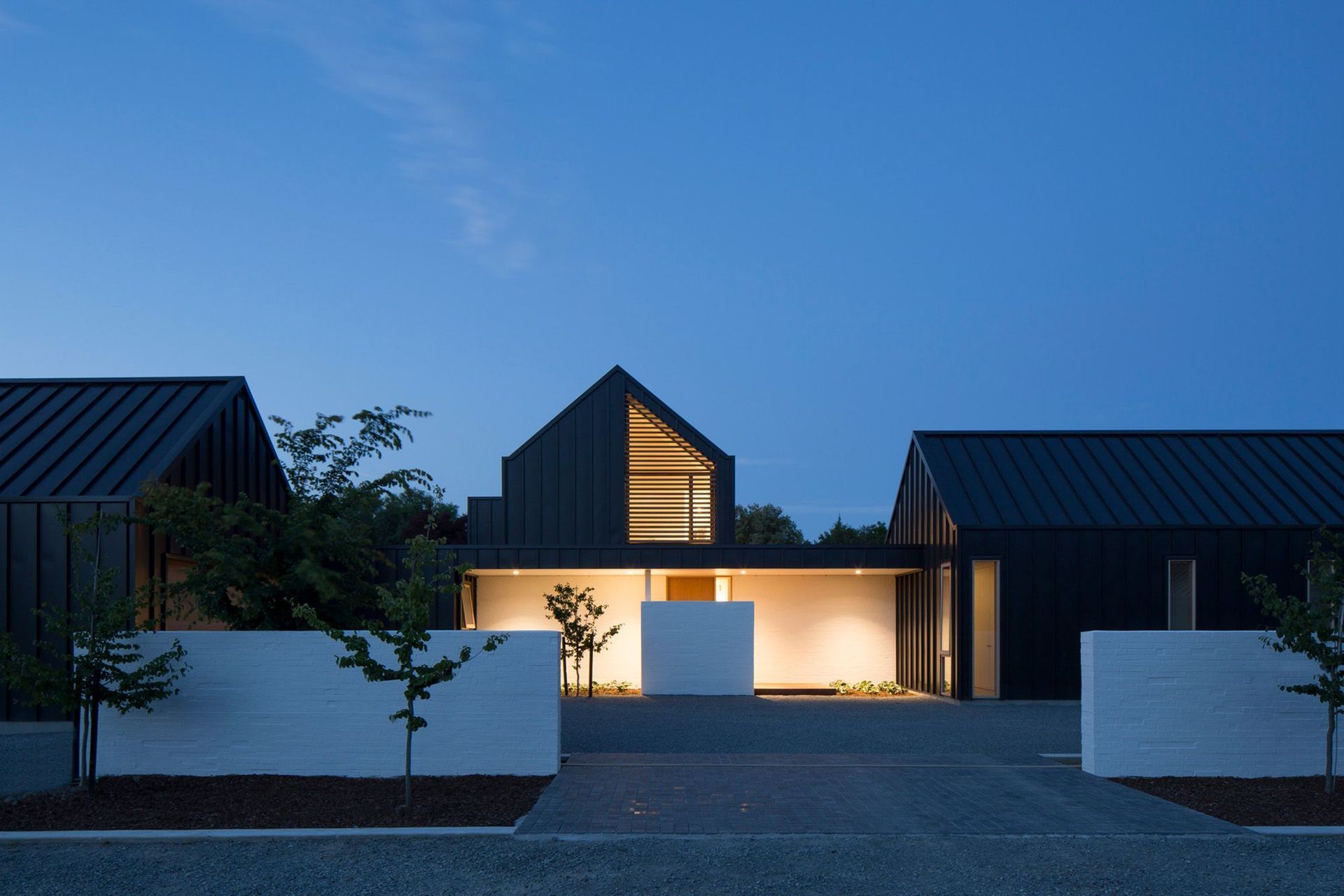 A street-front view of Ryan House lit up at night.