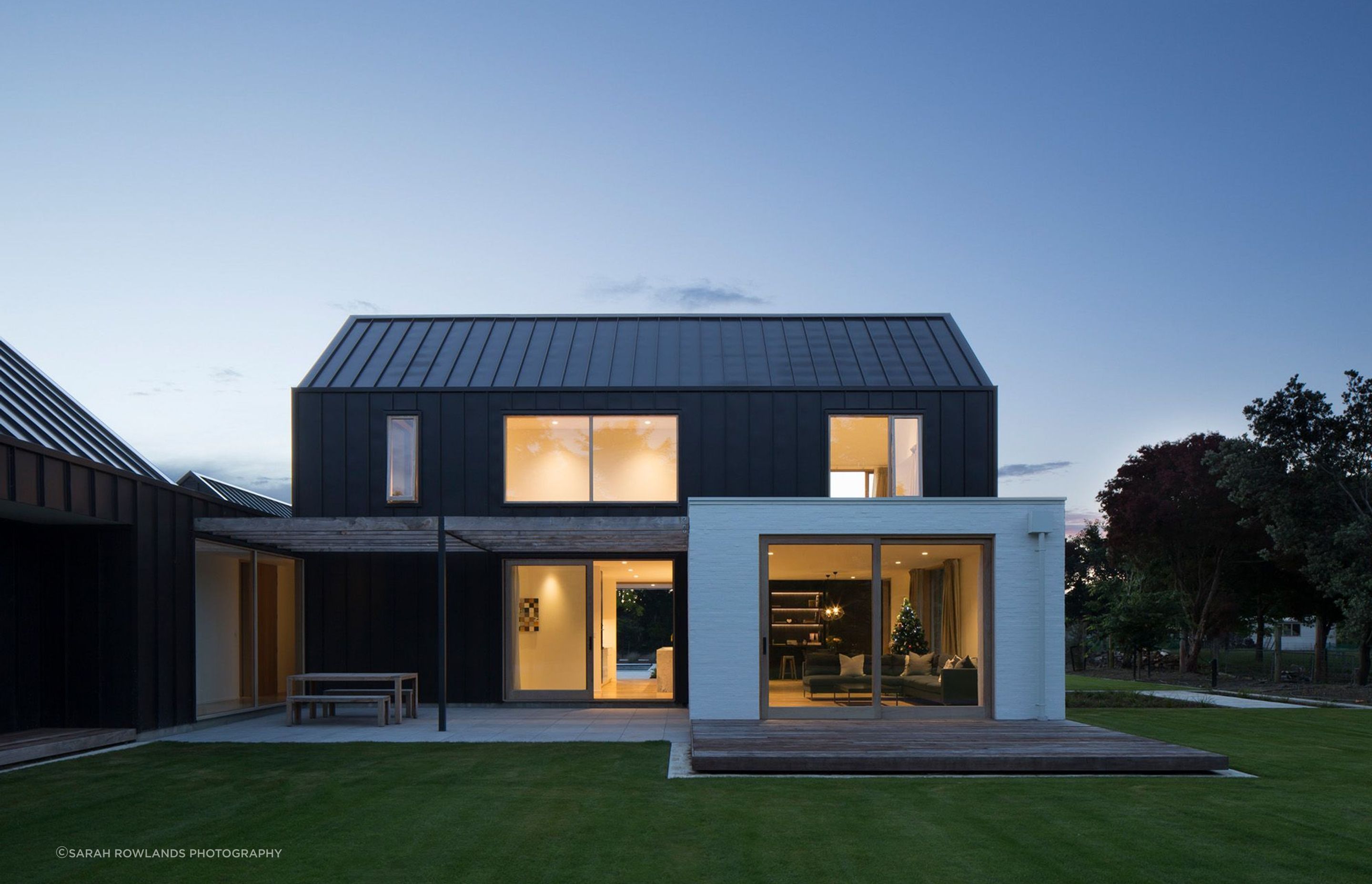 A night shot of the courtyard area, which features limestone tiling, kwila deckingand a cedar pergola timber pegola built from milled trees on the property.