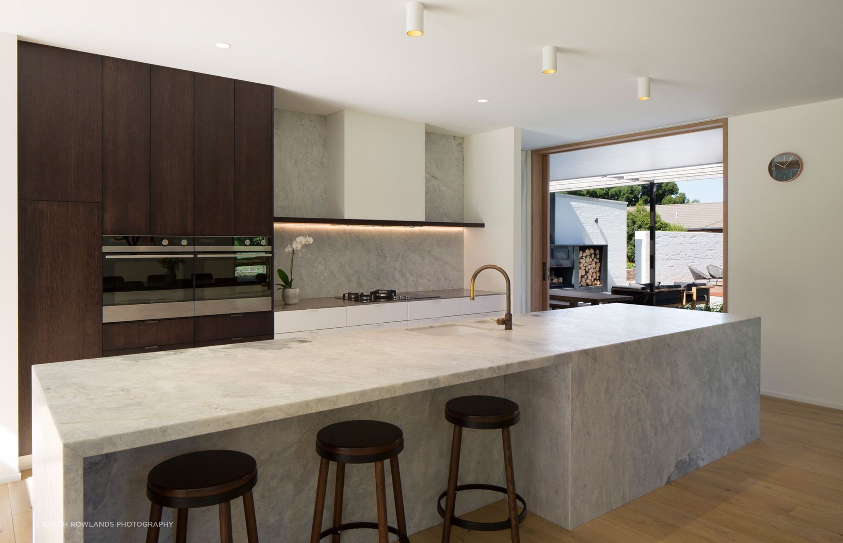 The kitchen has a modern yet timeless aesthetic through the use of natural materials in a refined neutral palette, with Fisher &amp; Paykel built-in duel ovens.