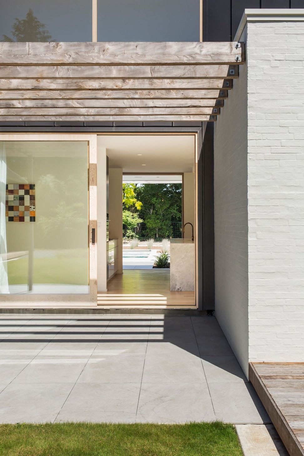 A sliding door leads from one terrace, through the kitchen to the pool area.
