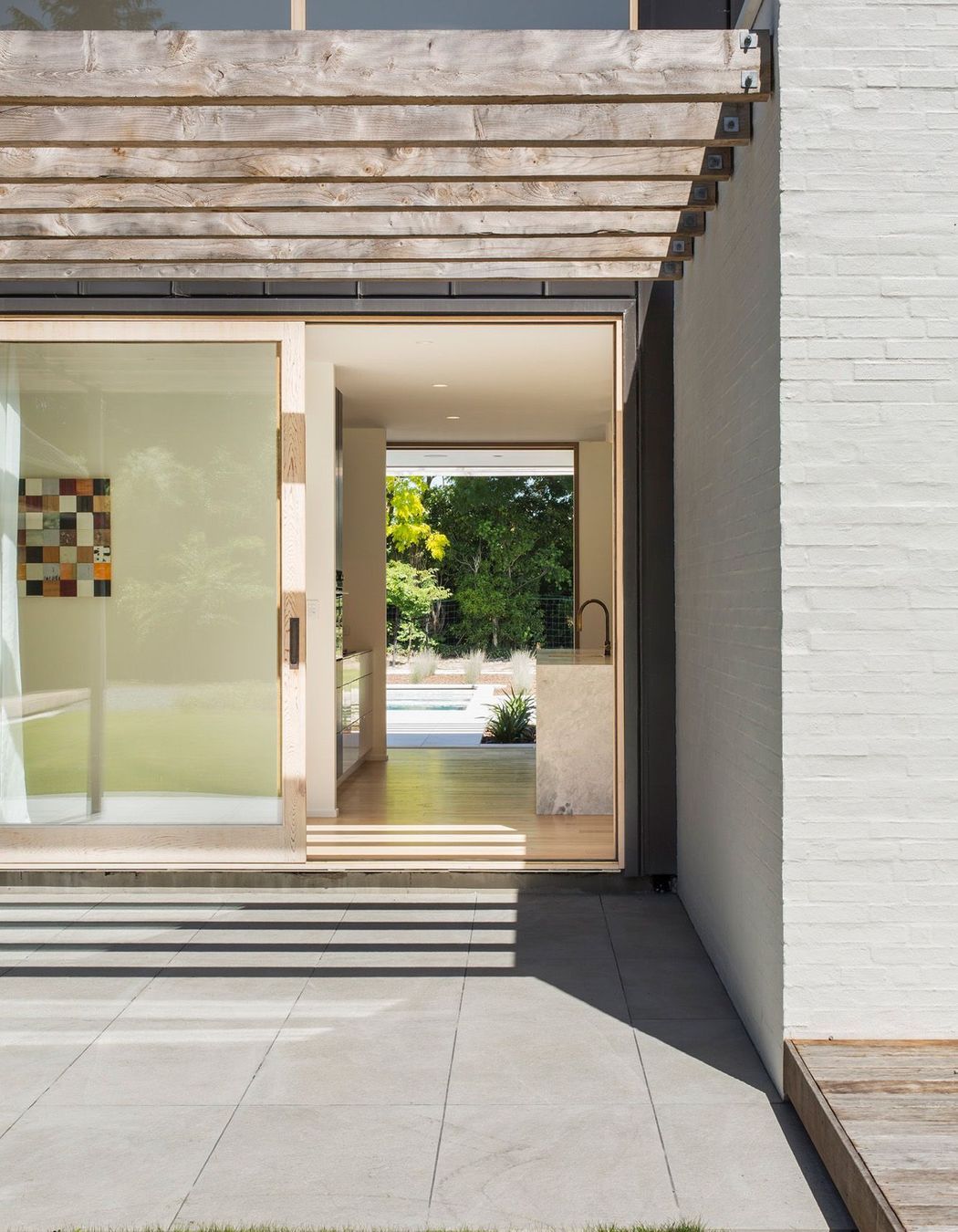 A sliding door leads from one terrace, through the kitchen to the pool area.