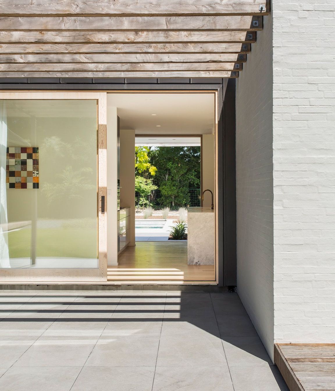 A sliding door leads from one terrace, through the kitchen to the pool area.