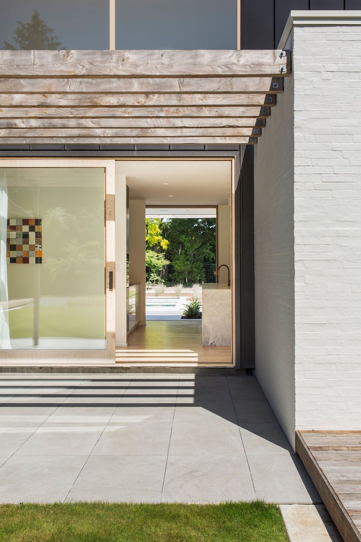 A sliding door leads from one terrace, through the kitchen to the pool area.