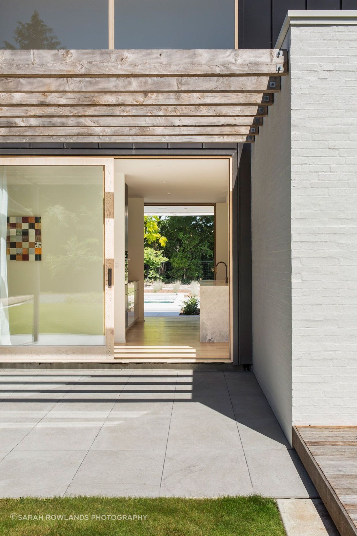 A sliding door leads from one terrace, through the kitchen to the pool area.